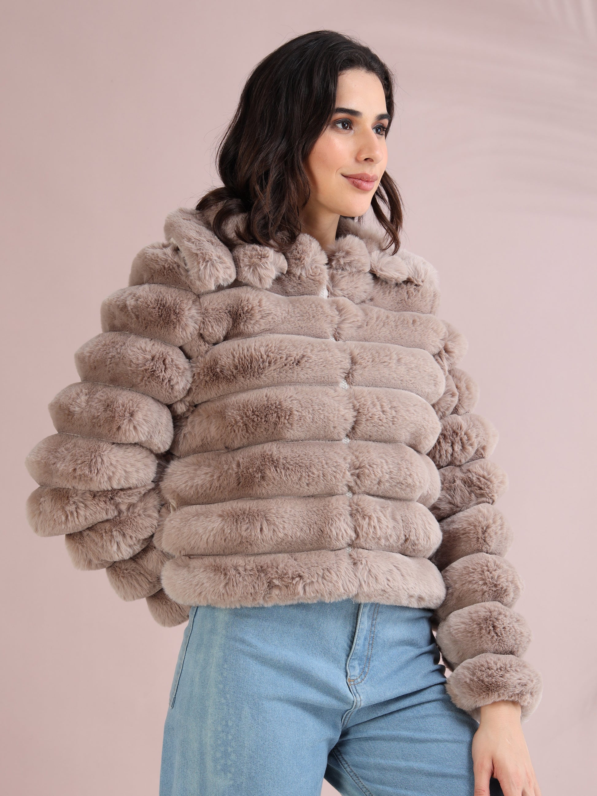 Stylish women’s beige faux fur jacket shown from side angle with puffed sleeves and cozy texture.