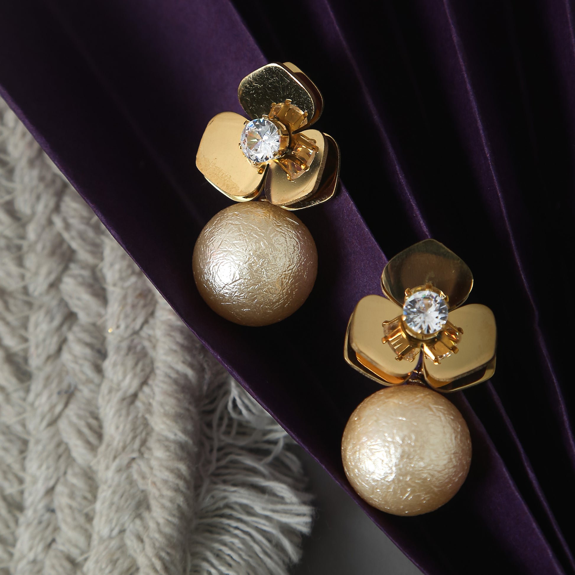 a gold plated floral earrings with sparkling crystal and textured pearl drops