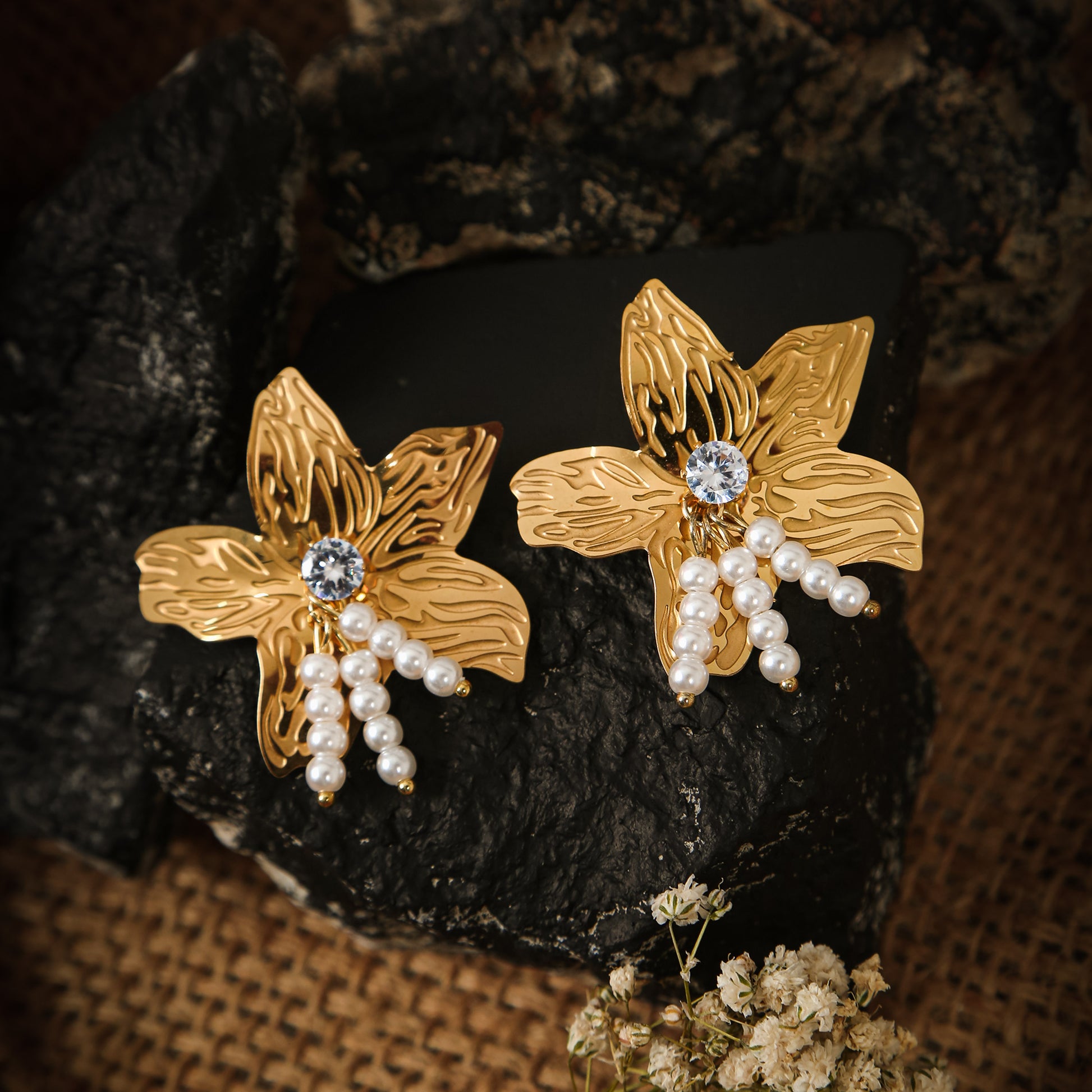 legant gold flower earrings with stone center and pearl dangle accents