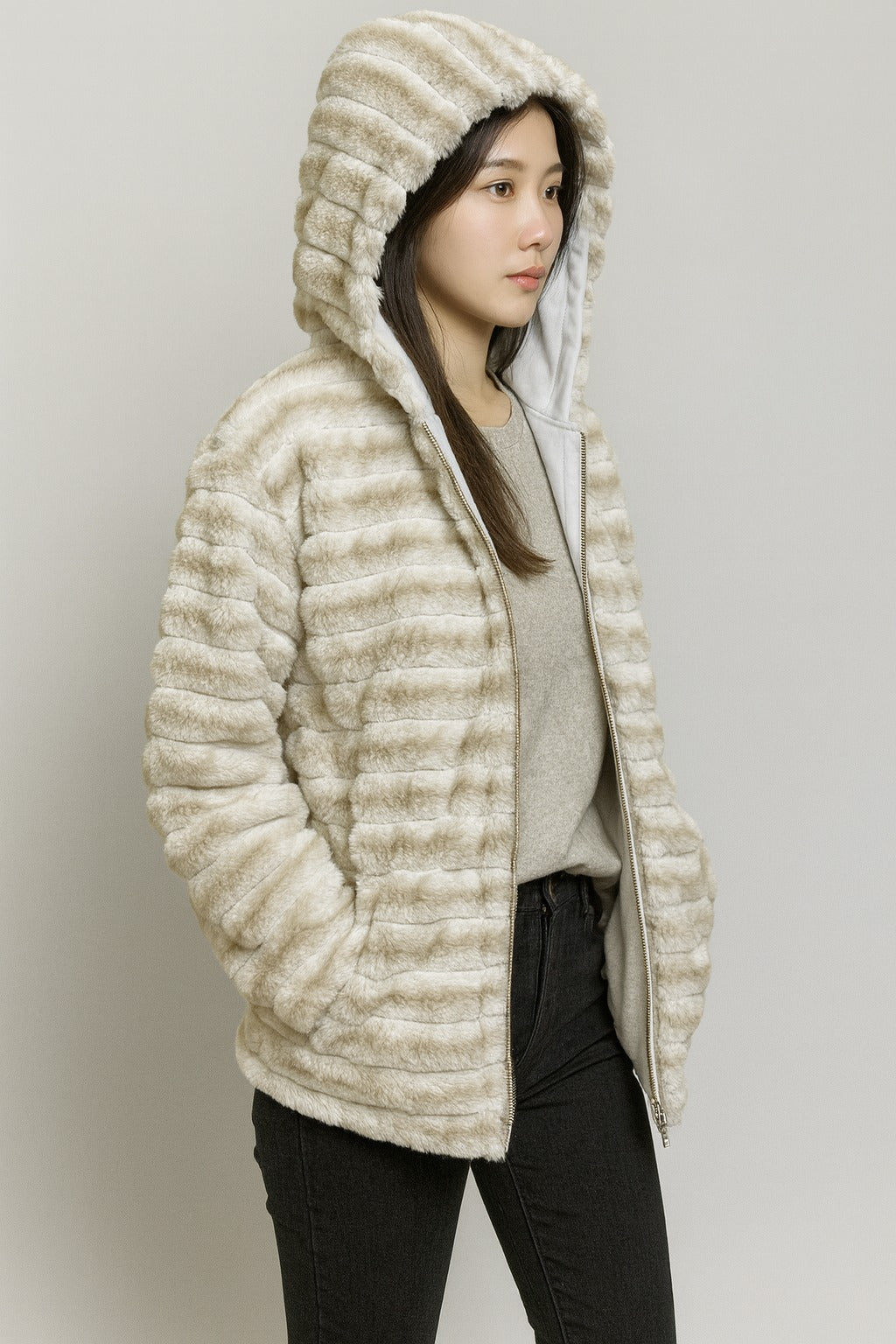 cream plush faux fur hooded jacket, hands in pockets, warm winter fashion outfit.