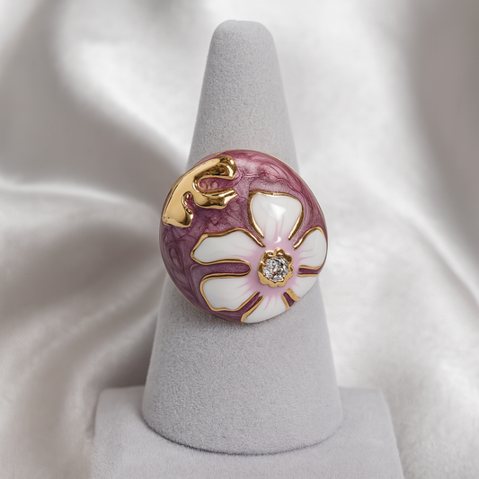 Luxury anti-tarnish ring featuring a white flower design on a purple enamel base with gold accents and a central diamond