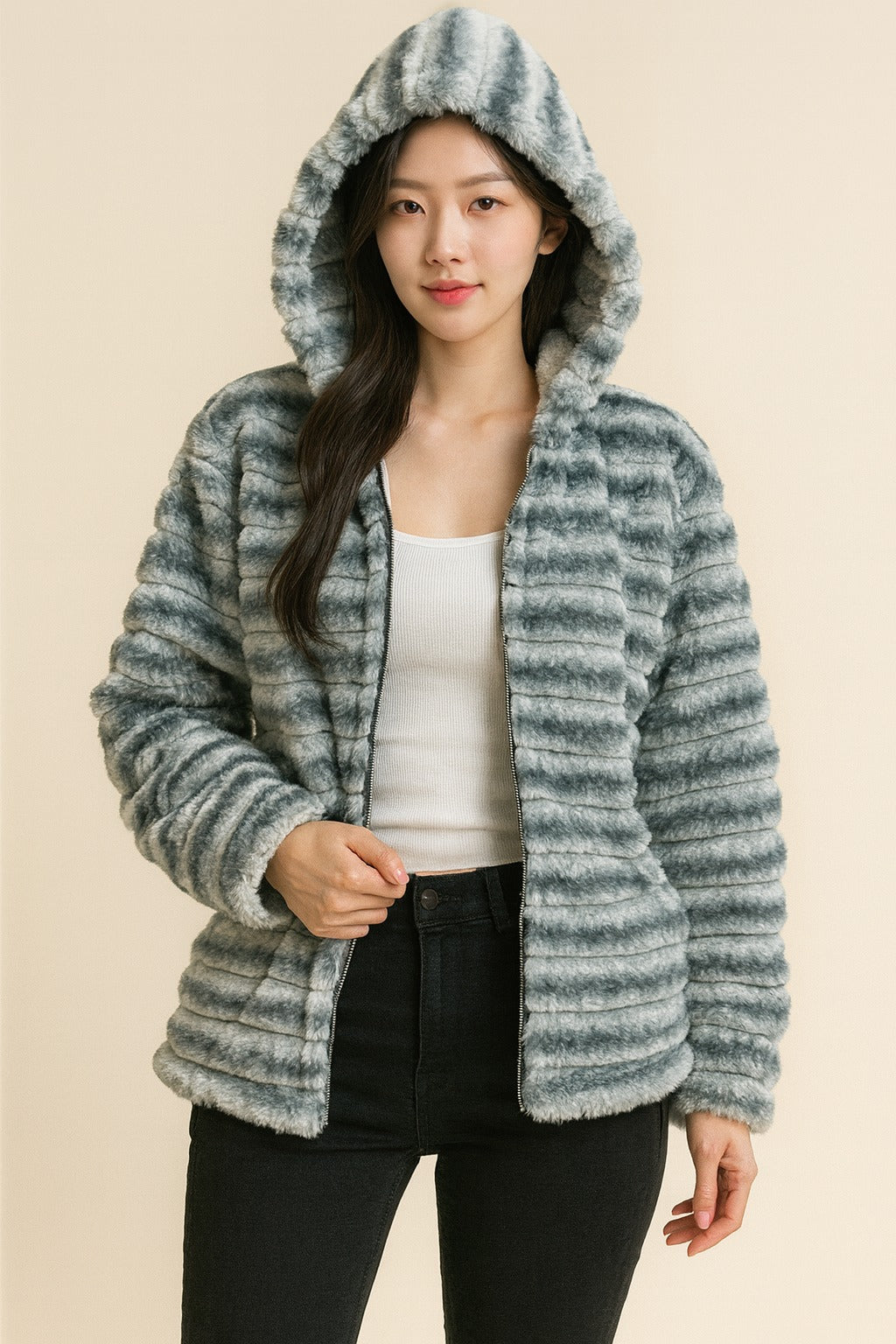 grey faux fur hooded jacket while walking outdoors, zip front, soft winter coat styling.