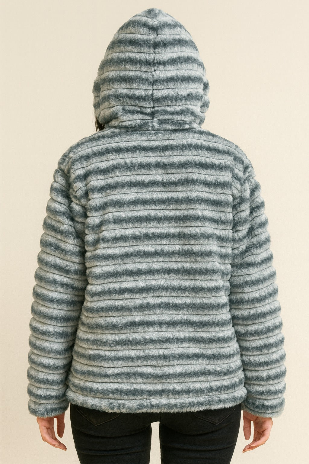grey faux fur winter jacket worn open over inner top, hood on, plush stripe texture, women’s cold-weather outfit