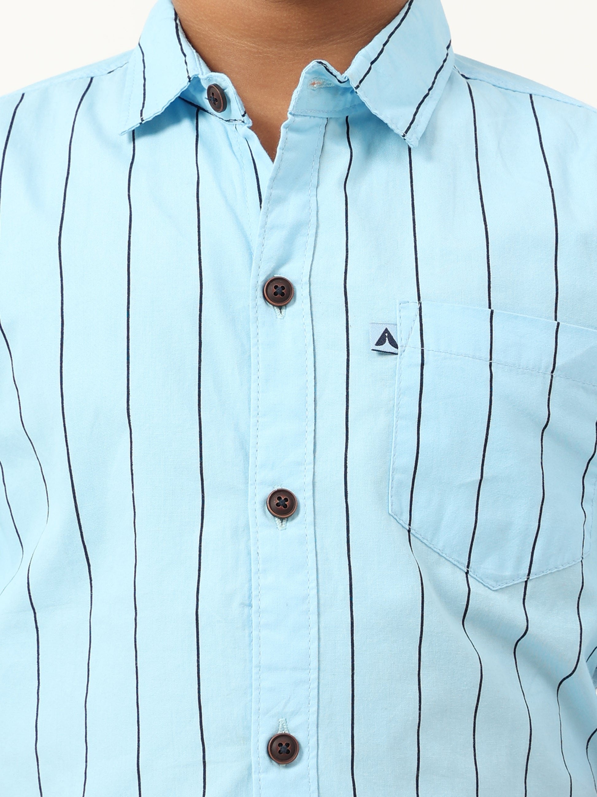 Light blue shirt with black vertical stripes and a small logo on a white background