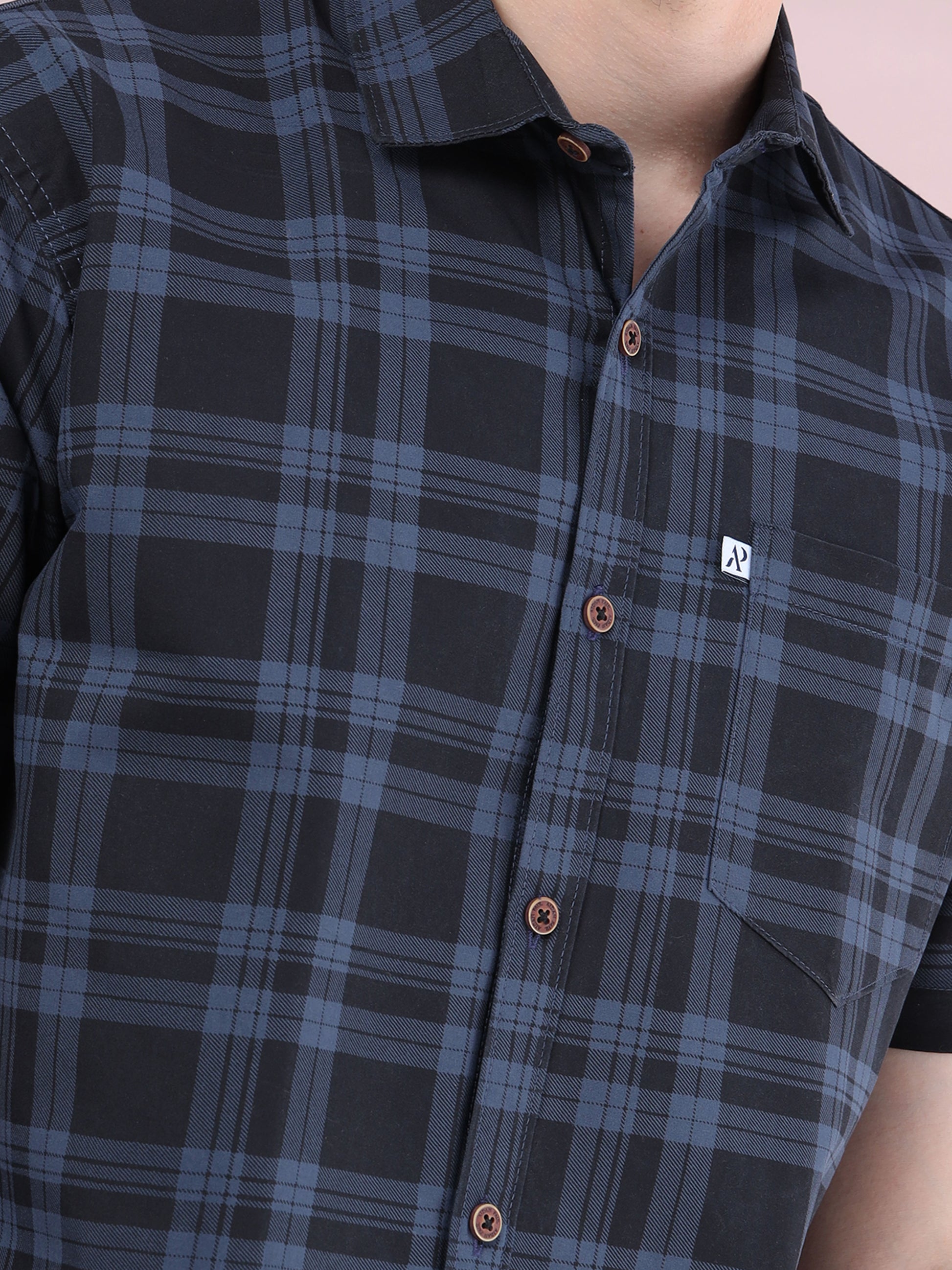 Detailed close-up of men, ash grey and black checked cotton fabric with button placket.