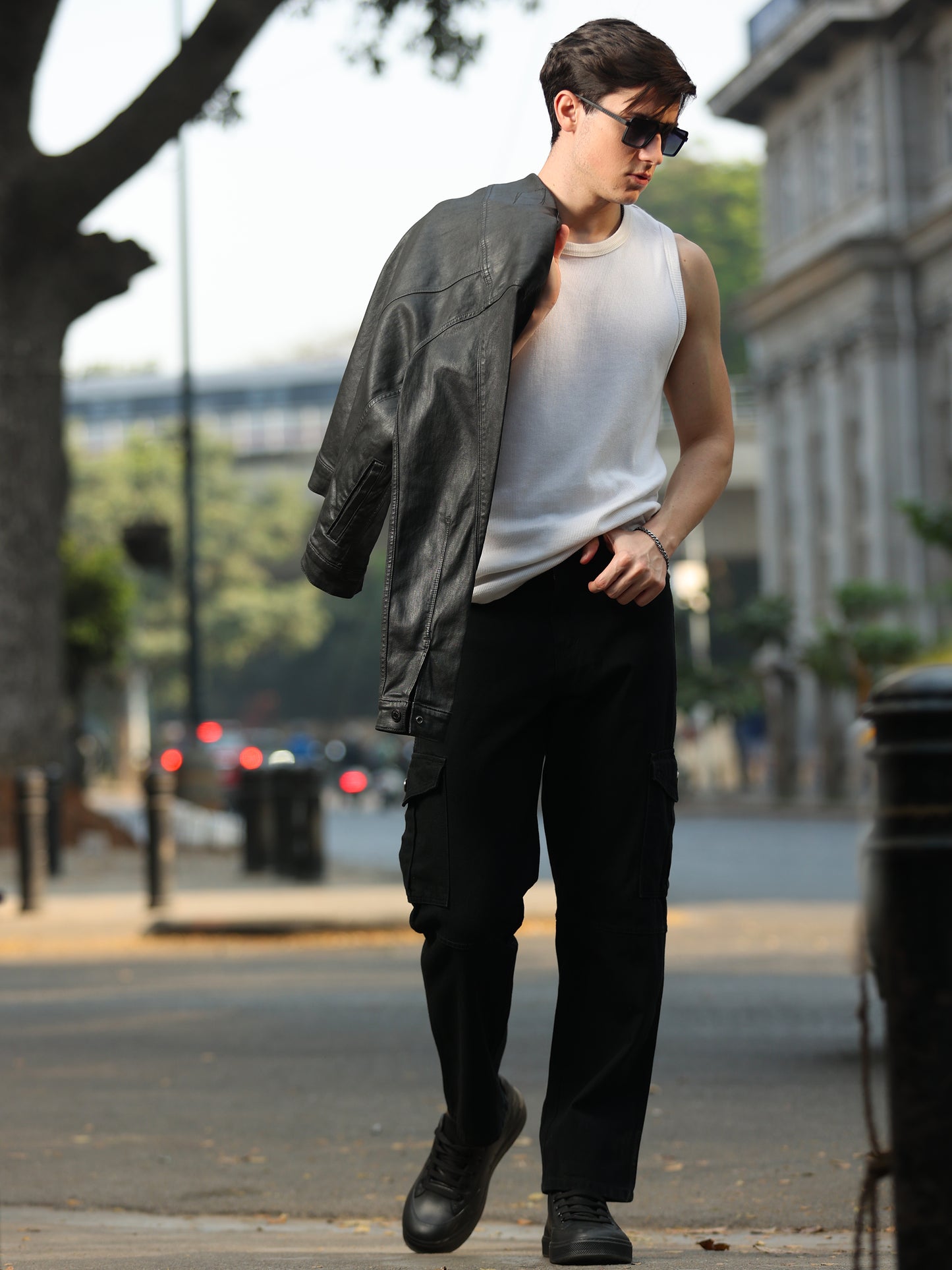 Casual men's black cargo pants paired with white sneakers