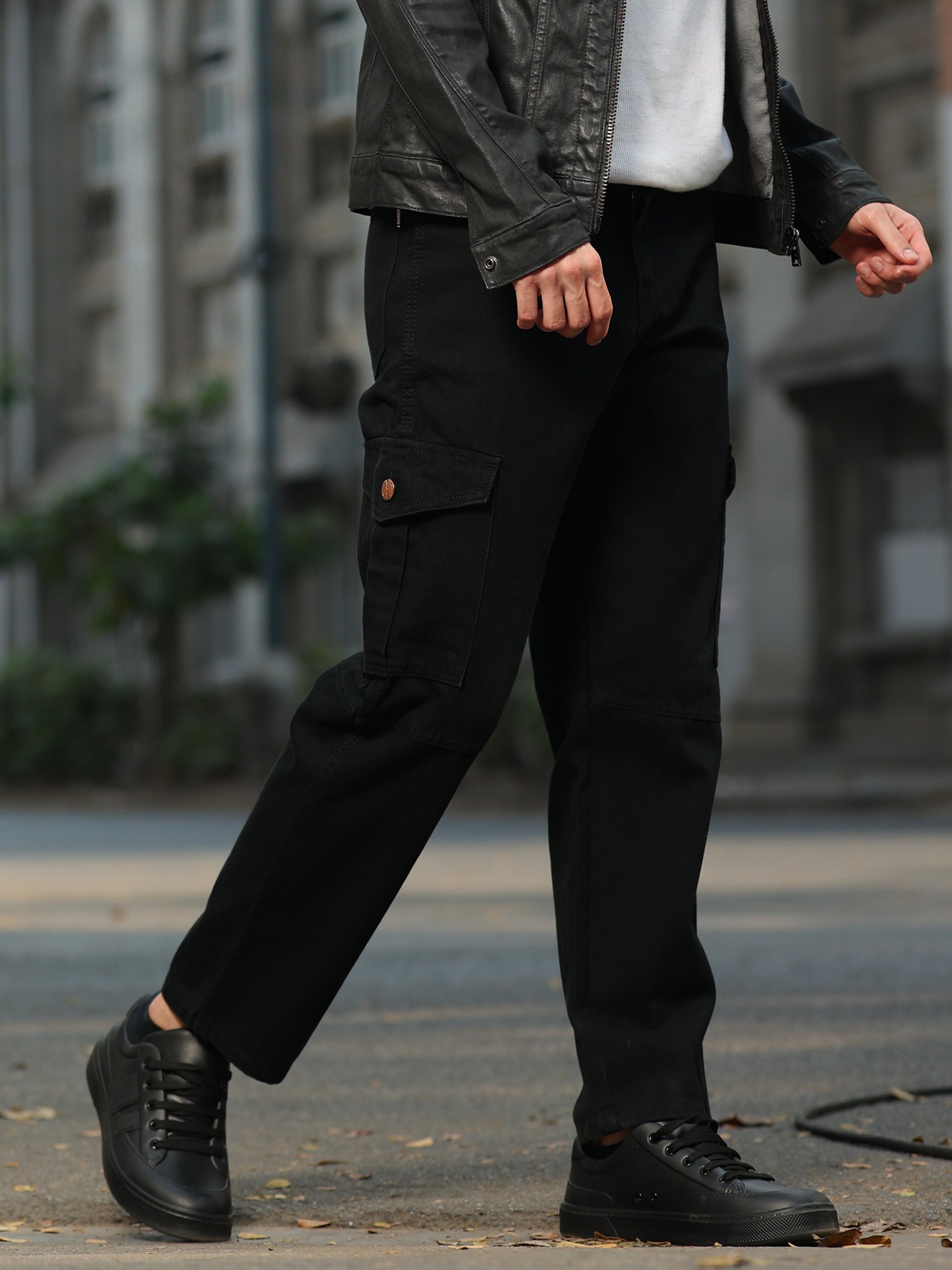 Casual men's black cargo pants paired with white sneakers