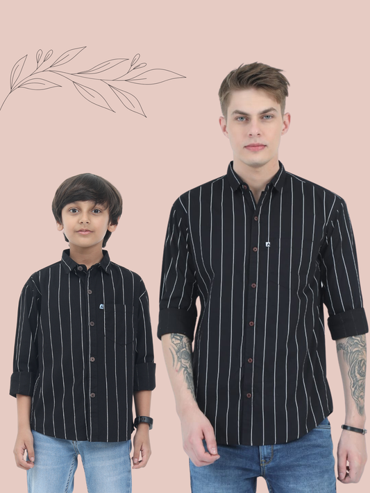 Two individuals wearing matching black striped shirts on a beige background