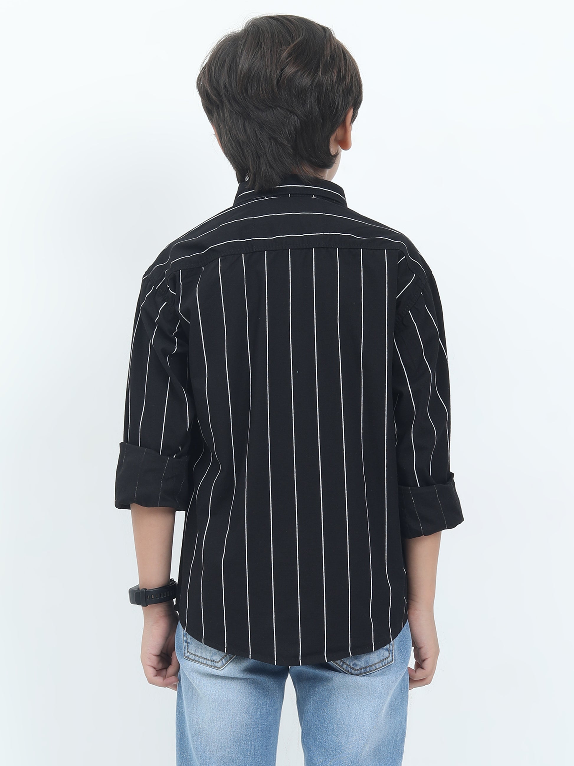 Person wearing a black striped shirt with rolled-up sleeves on a white background