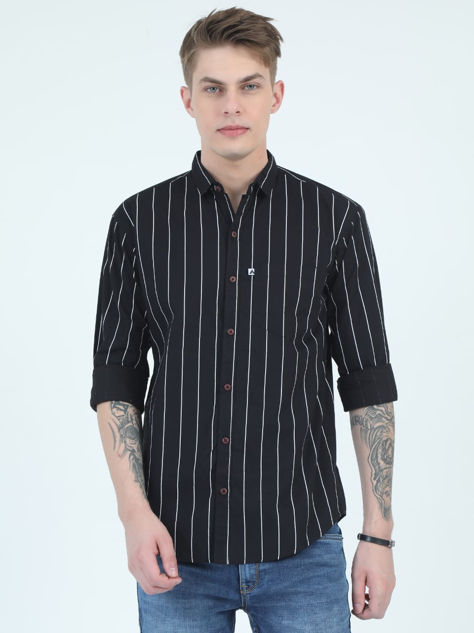 Man wearing a black striped shirt with rolled-up sleeves on a white background