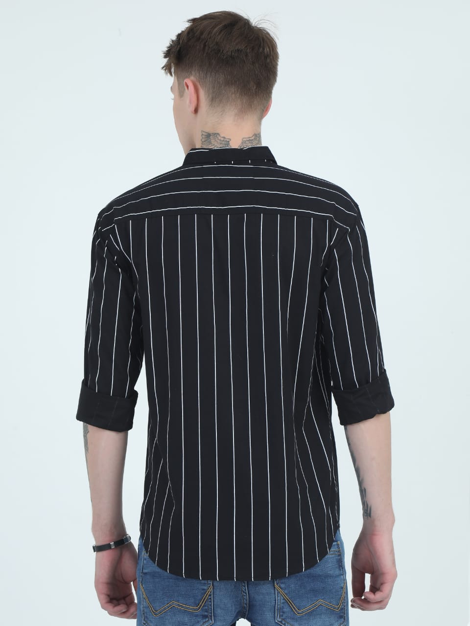 Person wearing a black pinstripe shirt on a white background