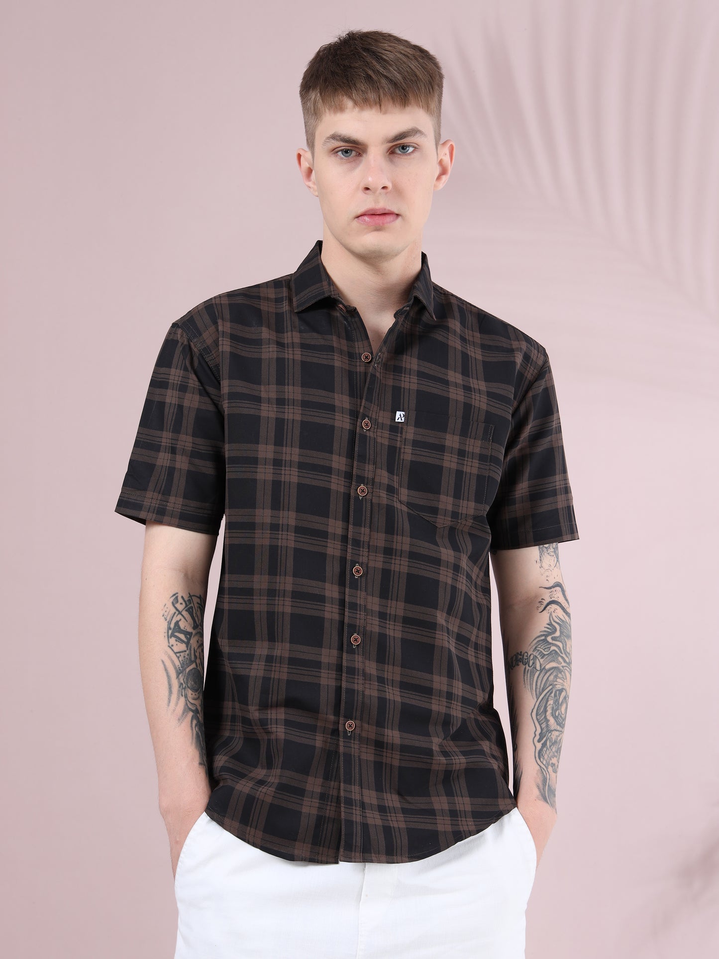 men, brown & black checkered slim fit short sleeve shirt with white trousers.