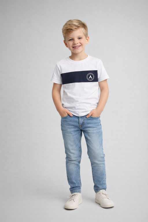 white t-shirt with navy stripe paired with blue jeans full body front pose trendy kids fashion wear.