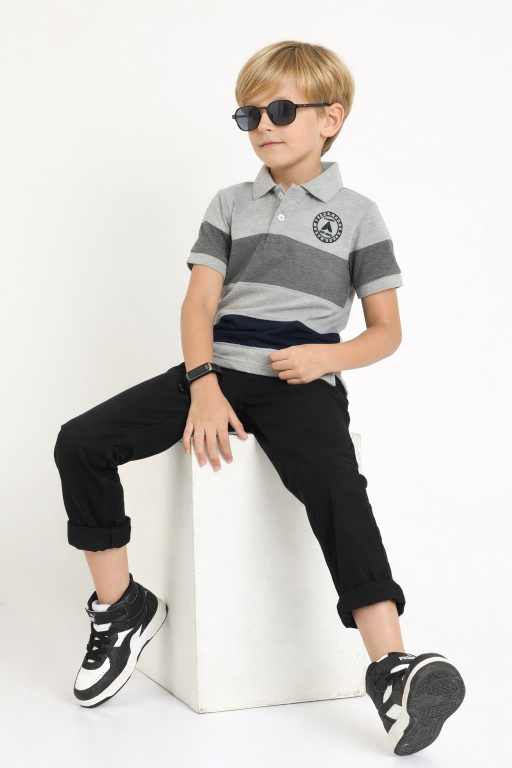 Stylish boys grey polo neck t-shirt paired with denim shorts front pose fashionable kids casual clothing.