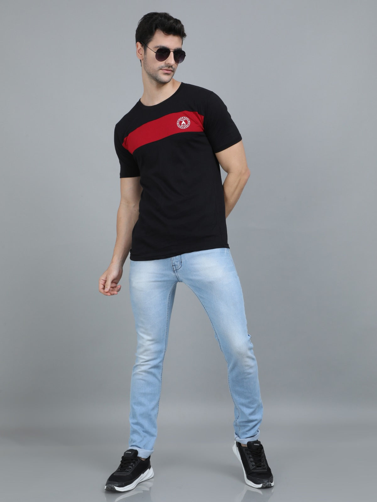 Fashionable men's black red striped t-shirt front pose for summer casual streetwear look.