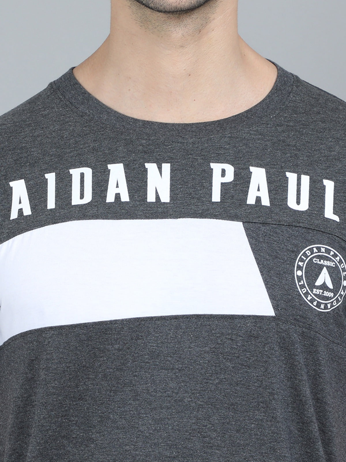 Stylish men's dark grey slim fit t-shirt with white printed chest panel modern casual outfit.