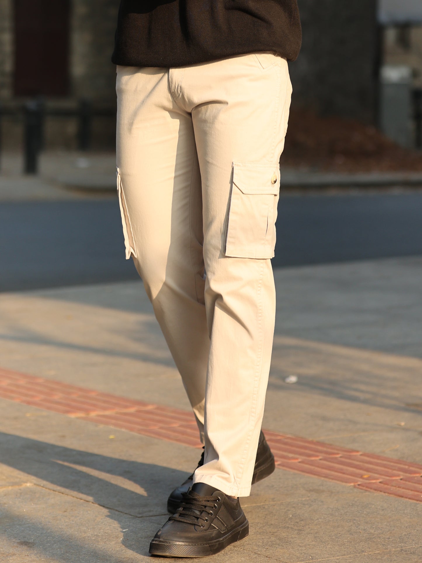 Stylish men's off-white cargo trousers with utility pockets and modern look