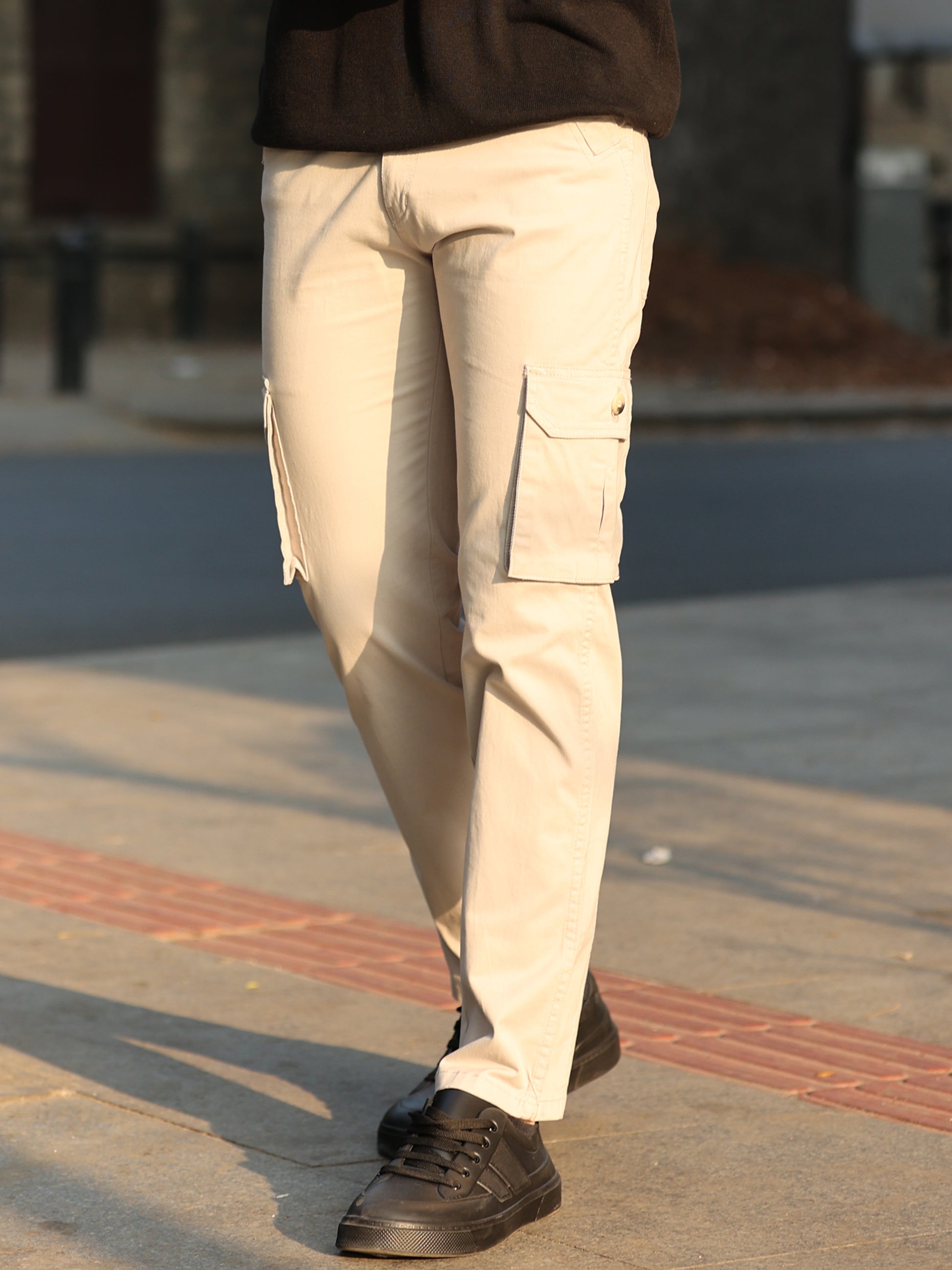 Stylish men's off-white cargo trousers with utility pockets and modern look