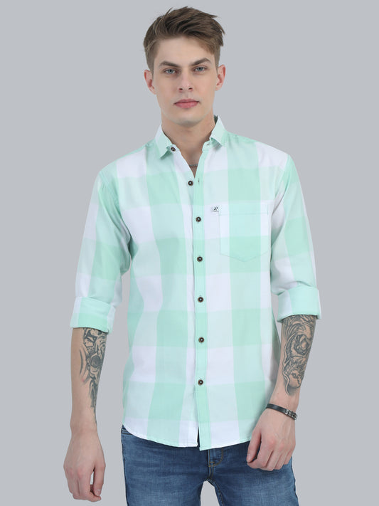 A man wearing a light green checkered shirt with full sleeves and a regular collar.