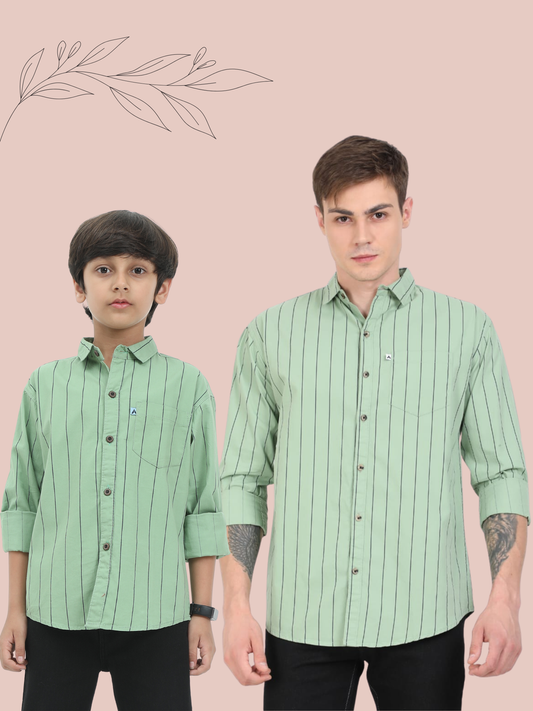 Two individuals wearing matching green striped shirts on a beige background