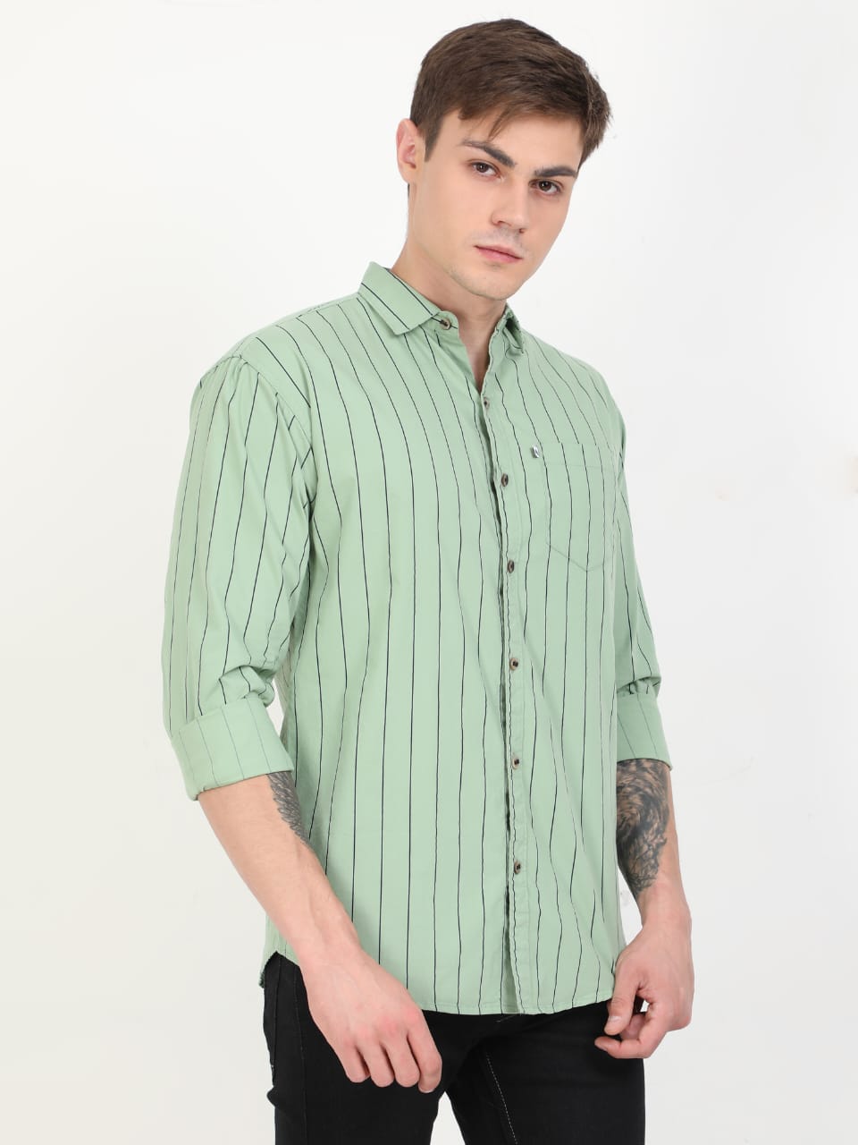 Man wearing a light green striped shirt on a white background