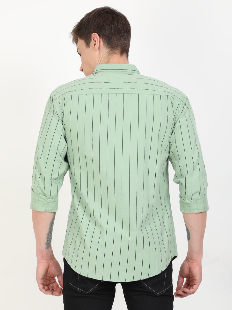Person wearing a light green striped shirt on a white background