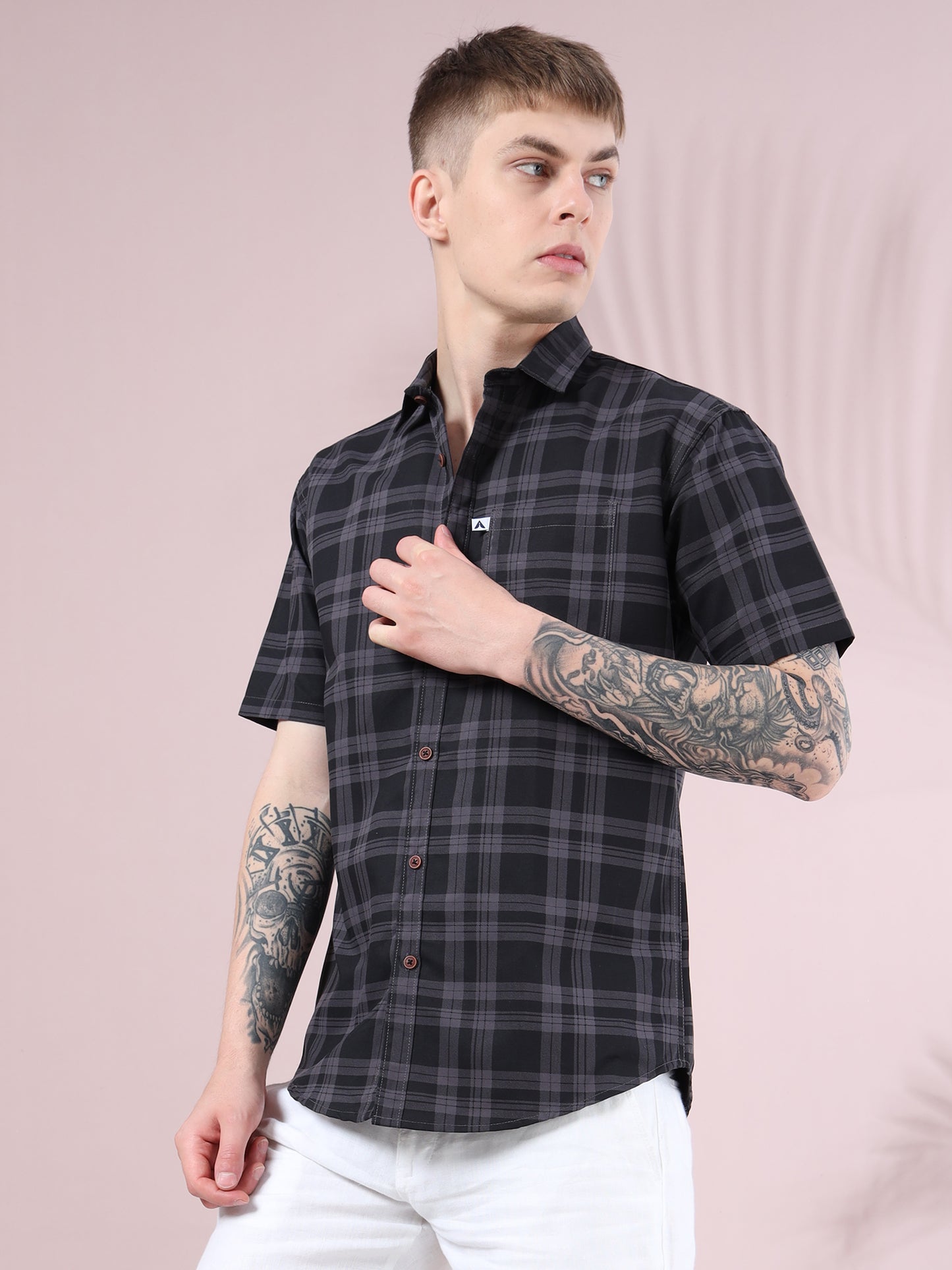 Stylish men black and grey checkered short sleeve shirt paired with white pants  casual summer wear.