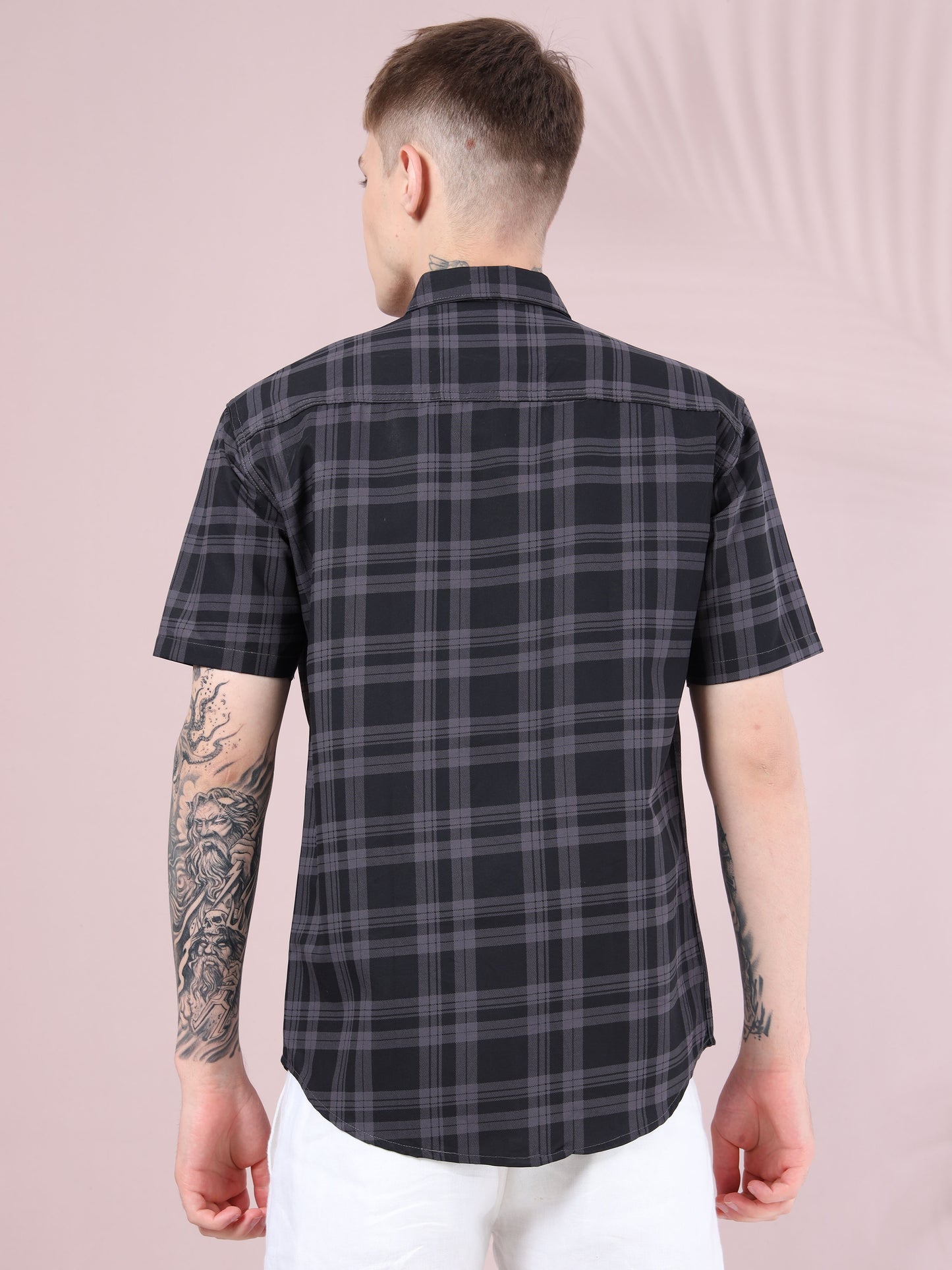 Back view of men, black and grey checked shirt, short sleeves and curved hem.