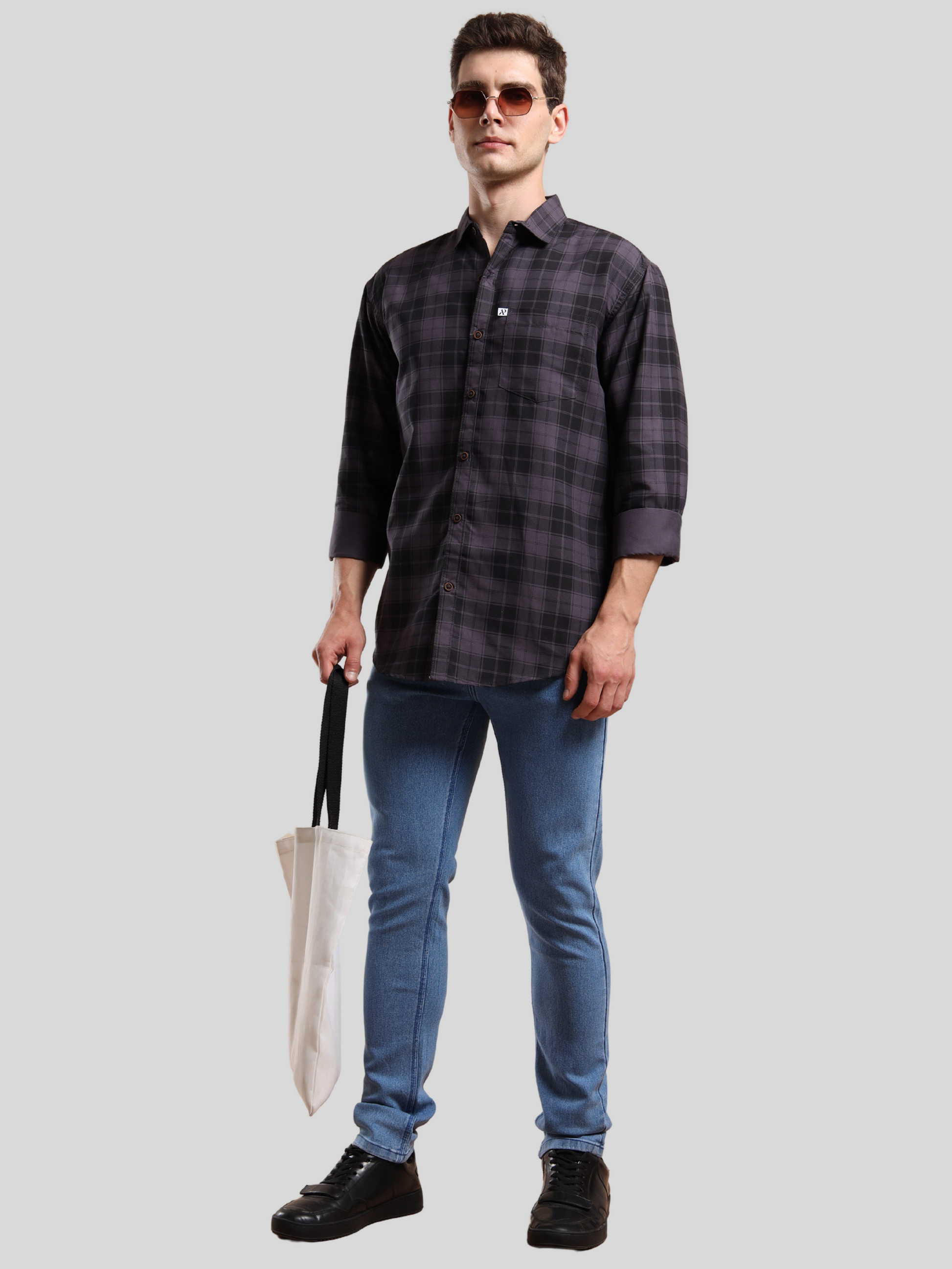 men, black checks shirt paired with jeans and sunglasses