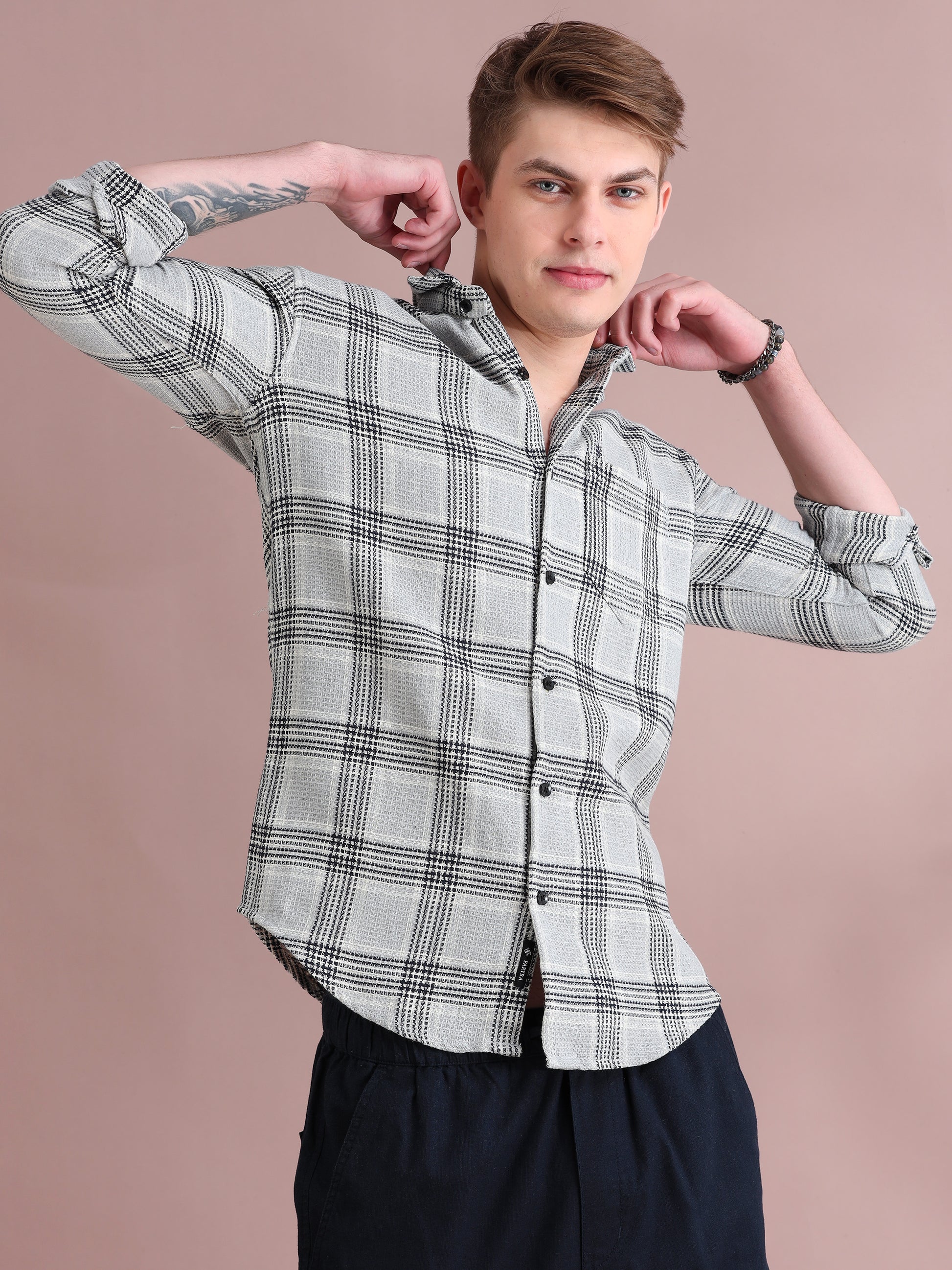 Men's light grey check shirt with black plaid pattern and rolled sleeves