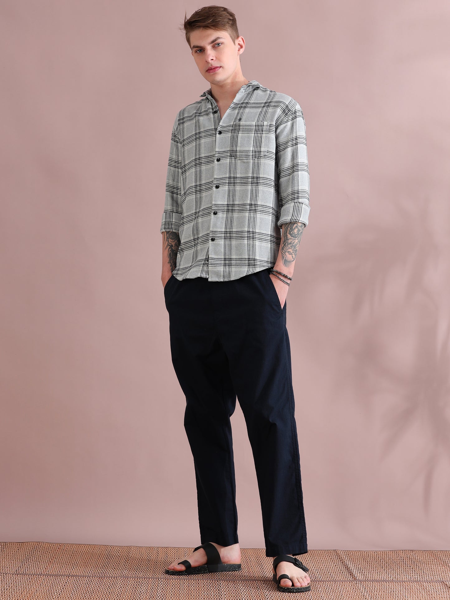 Casual men's grey checks shirt paired with black pants studio look