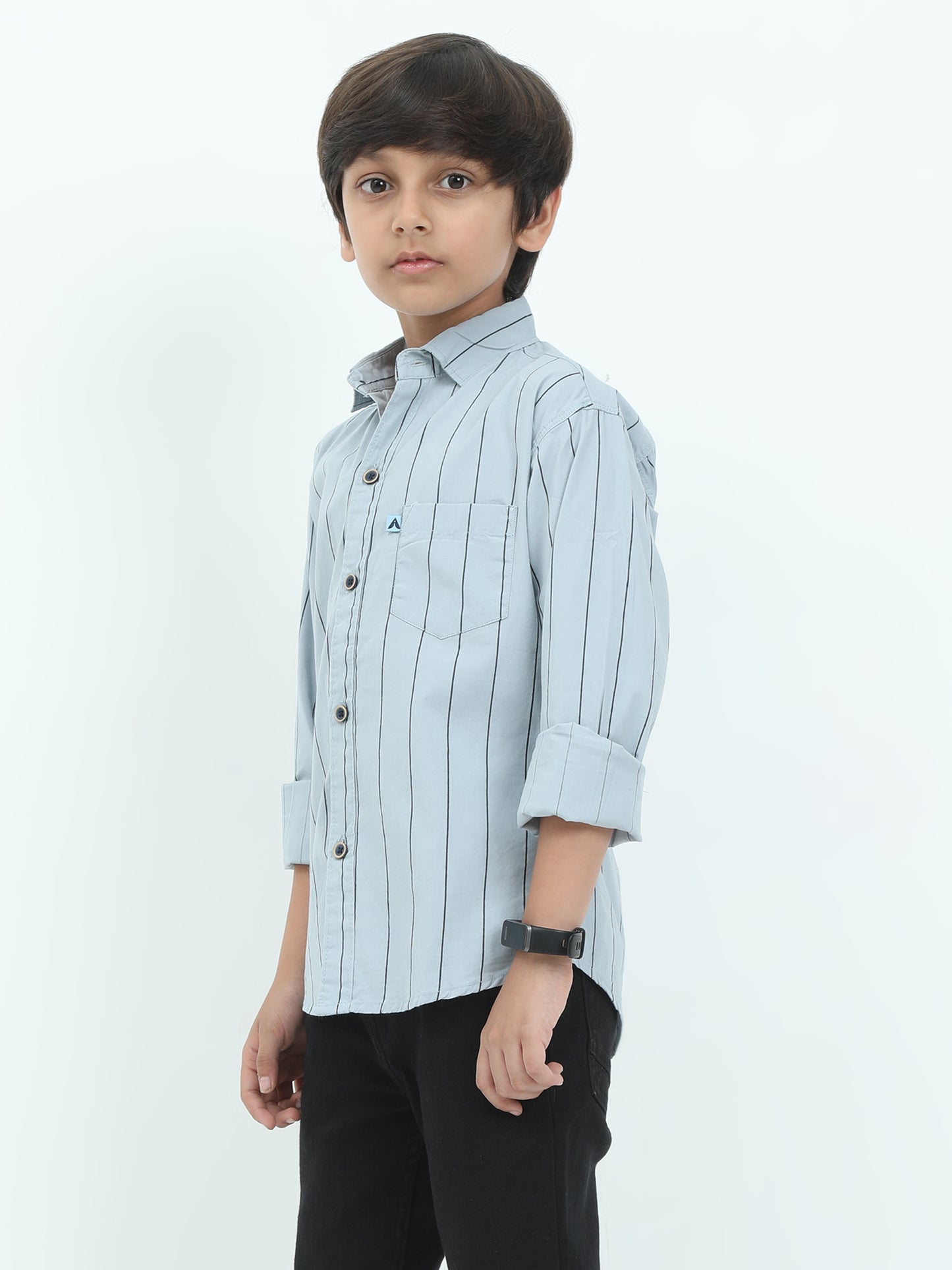 Young boy wearing a light blue striped shirt on a white background