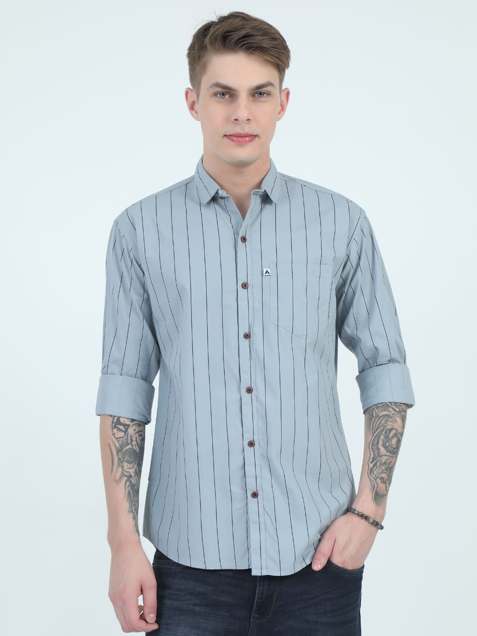Man wearing a light blue striped shirt on a white background