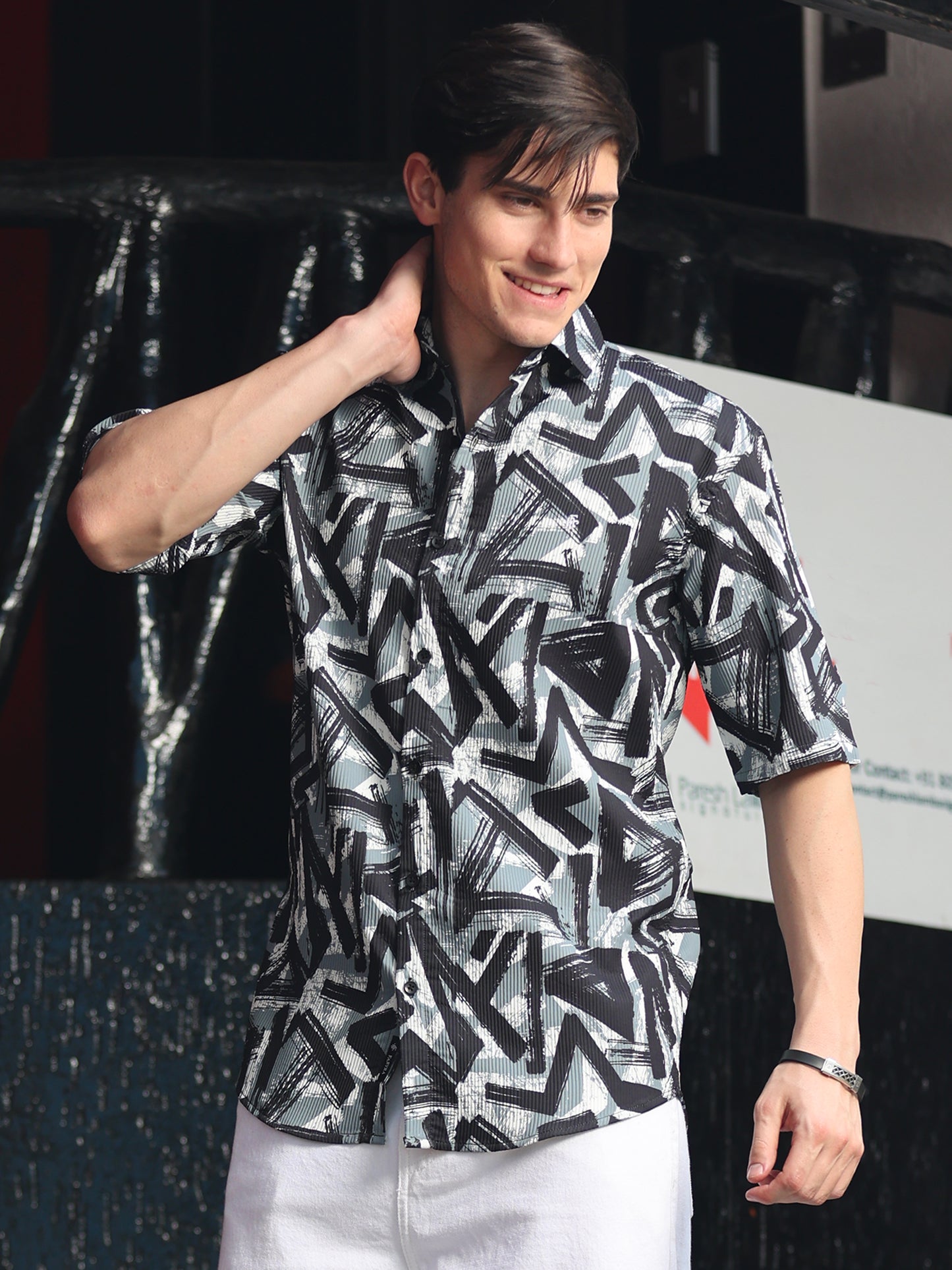Stylish man wearing monochrome geometric print shirt with casual summer look