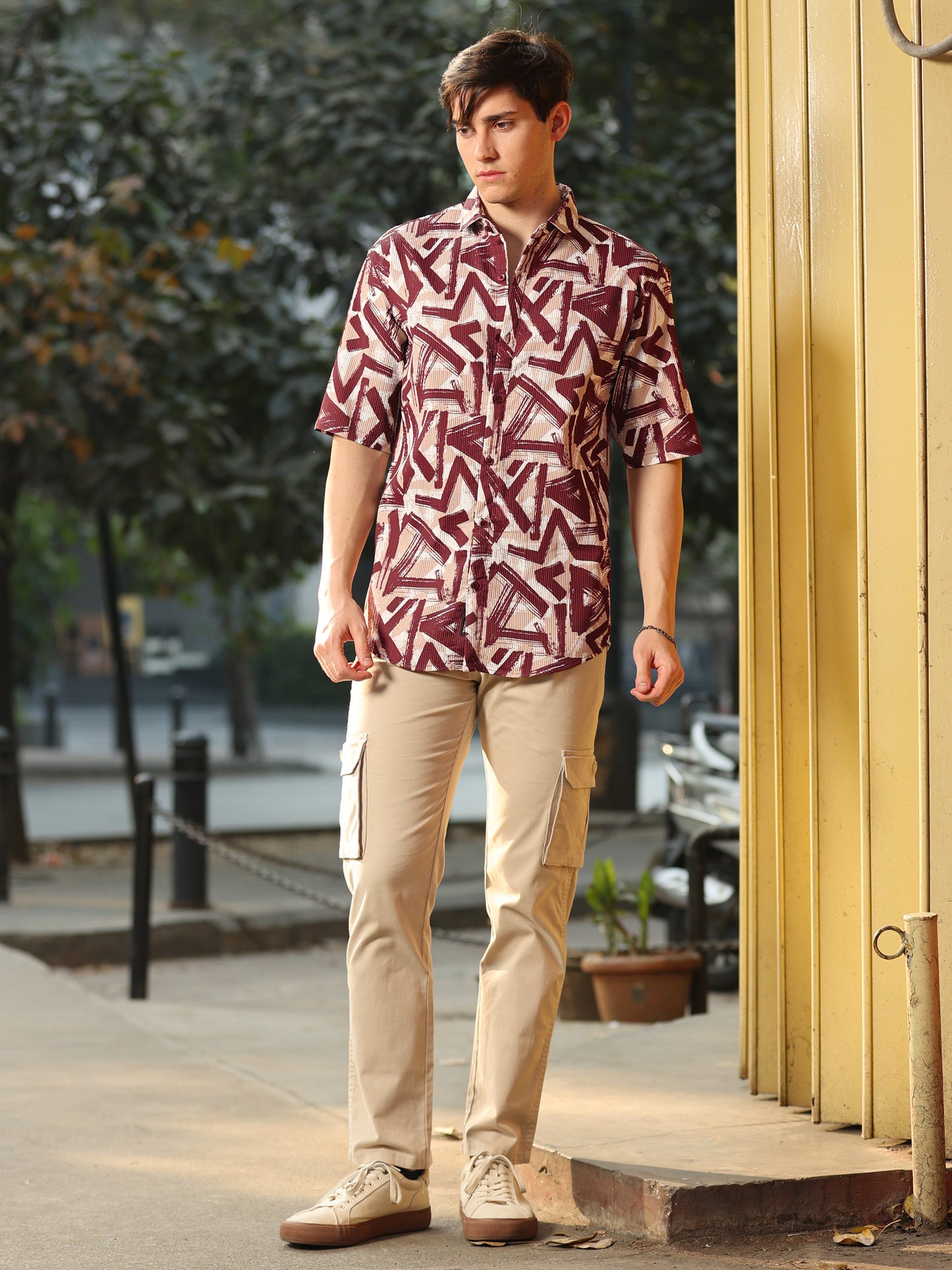Stylish man wearing maroon and beige geometric print casual shirt