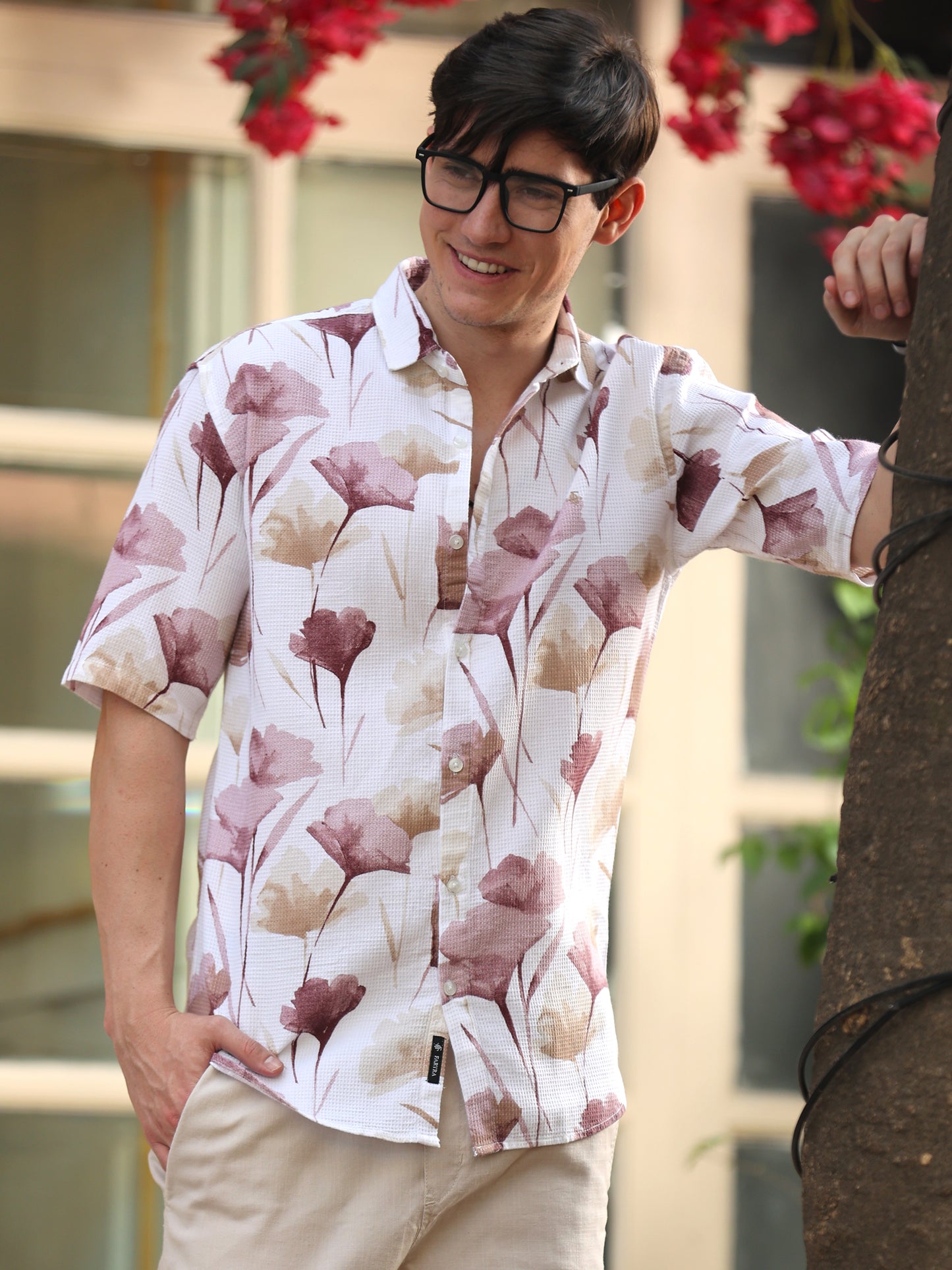 Stylish man wearing white short sleeve shirt with soft floral print design
