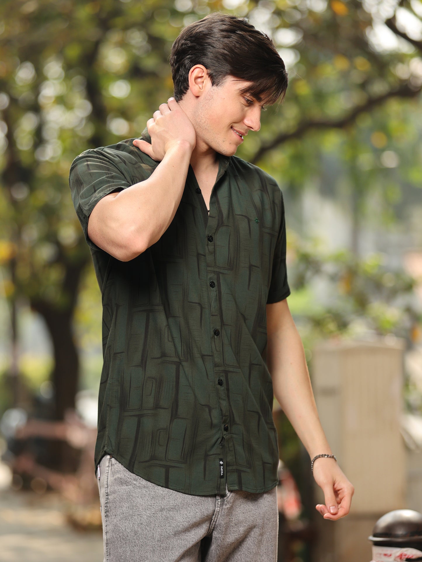 Trendy men's green half sleeve shirt with modern pattern and button-down front