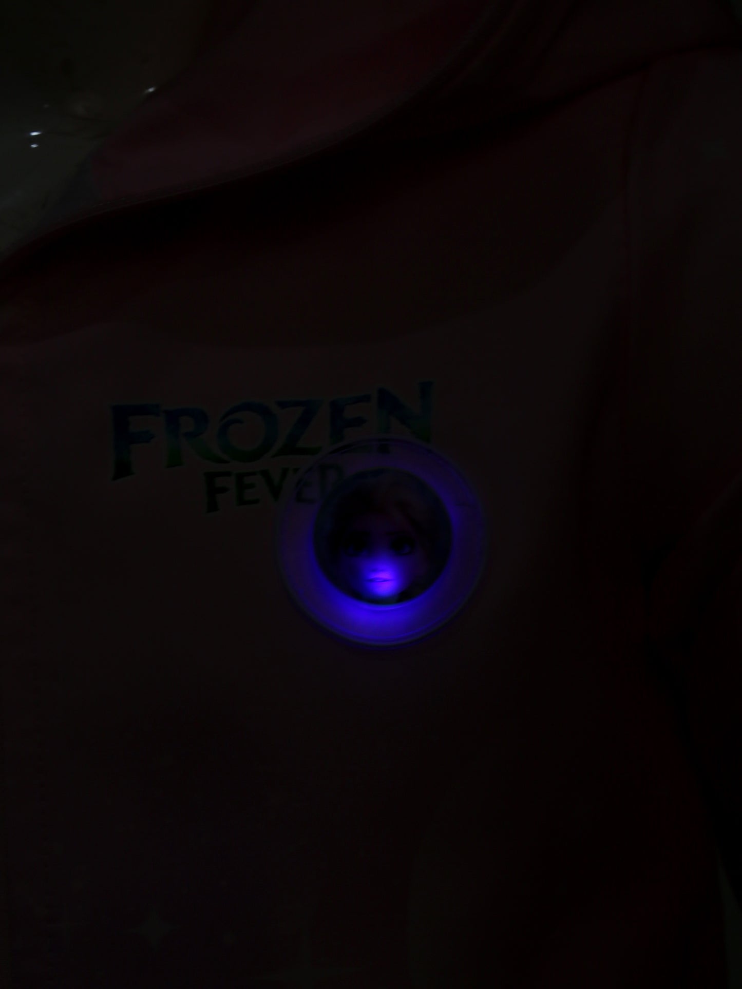 Dark shirt with 'Frozen Fever' text and blue light in the center