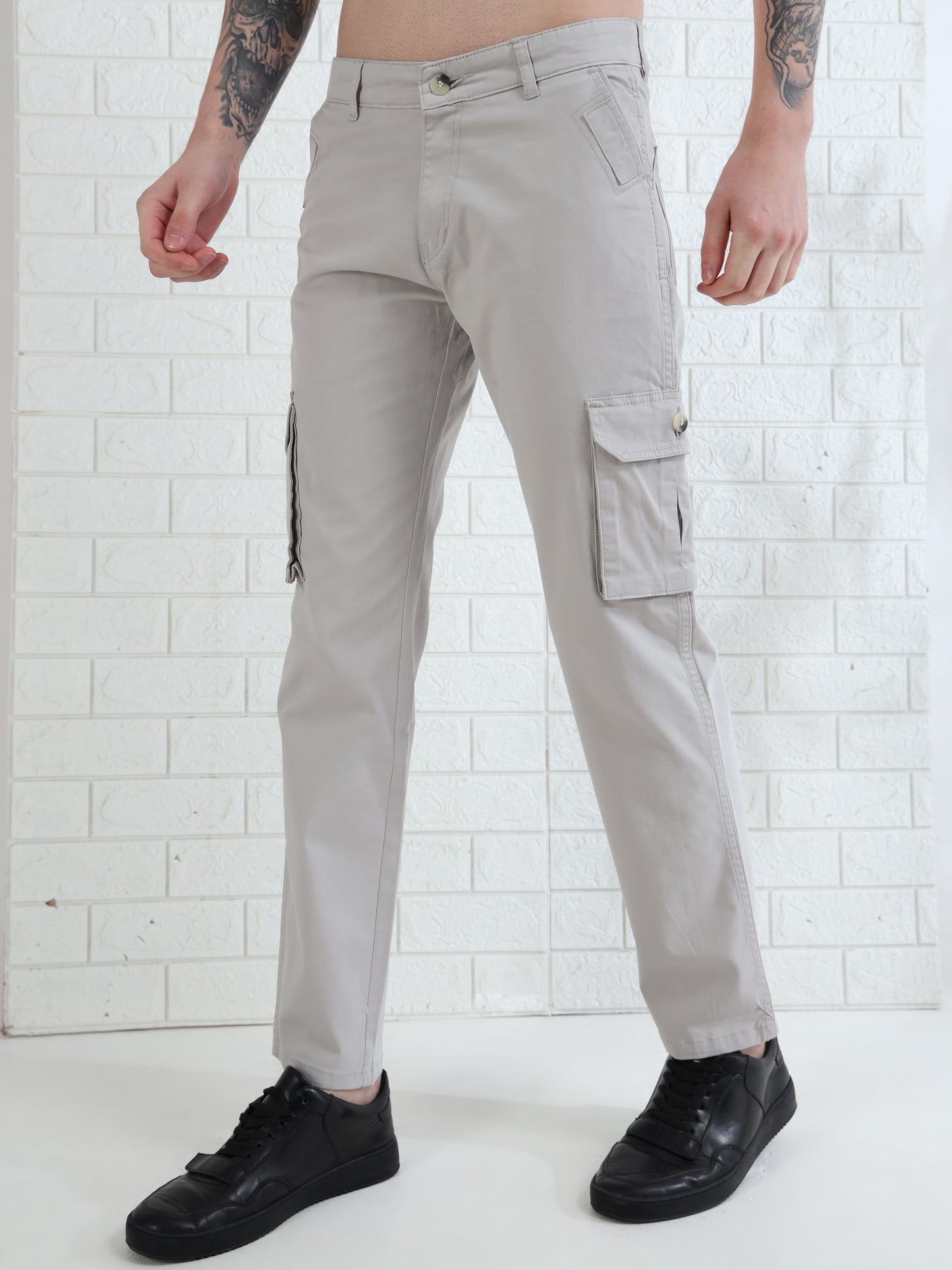 Stylish men's grey cargo trousers with utility pockets and modern slim look