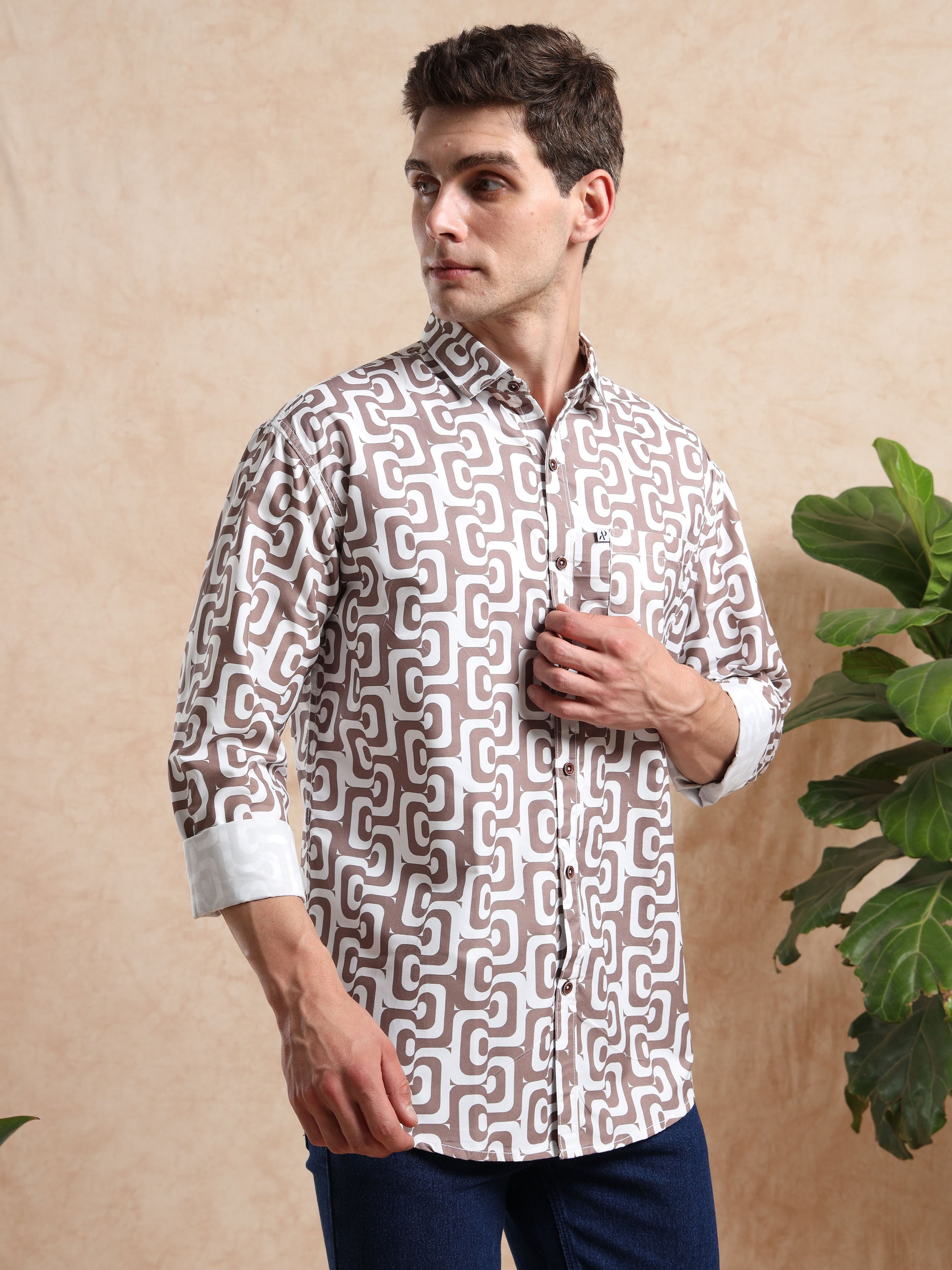 Full-sleeve brown designer printed shirt styled with denim, perfect for casual and party wear.