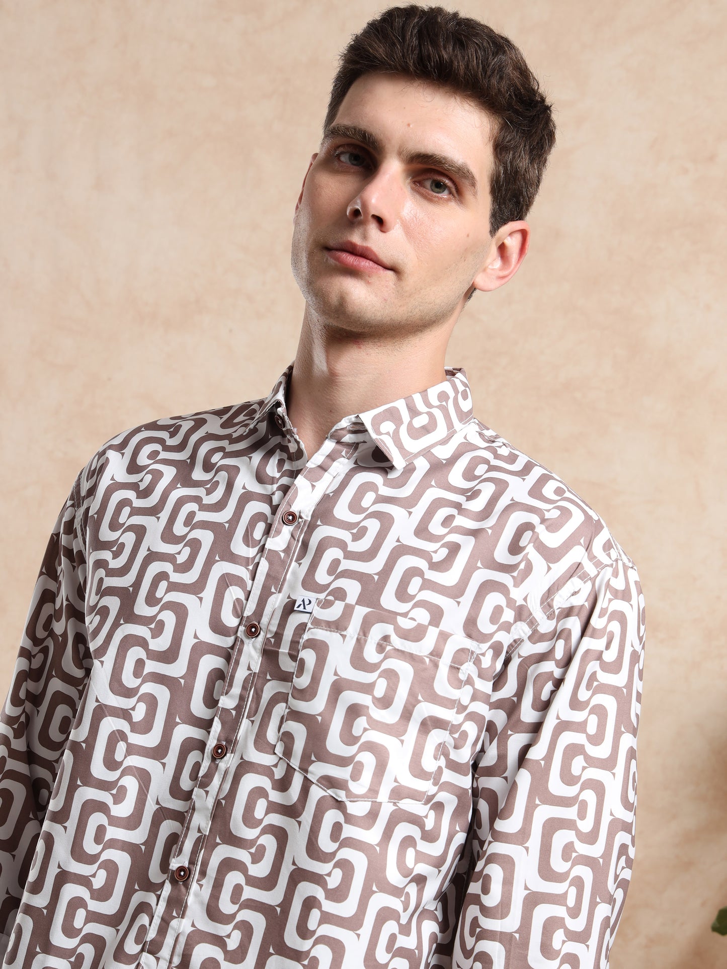 Detailed view of men, casual printed shirt in ash grey with bold geometric patterns.