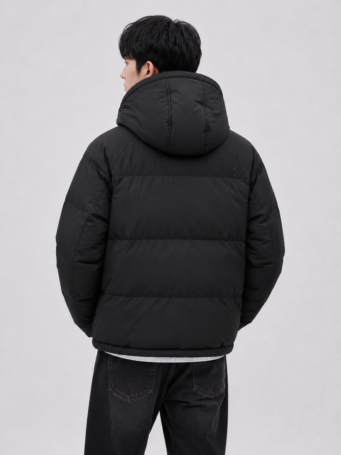 a men's black hooded puffer jacket featuring quilted insulation, a protective hood, full sleeves, and a clean minimalist design for cold-weather wear.