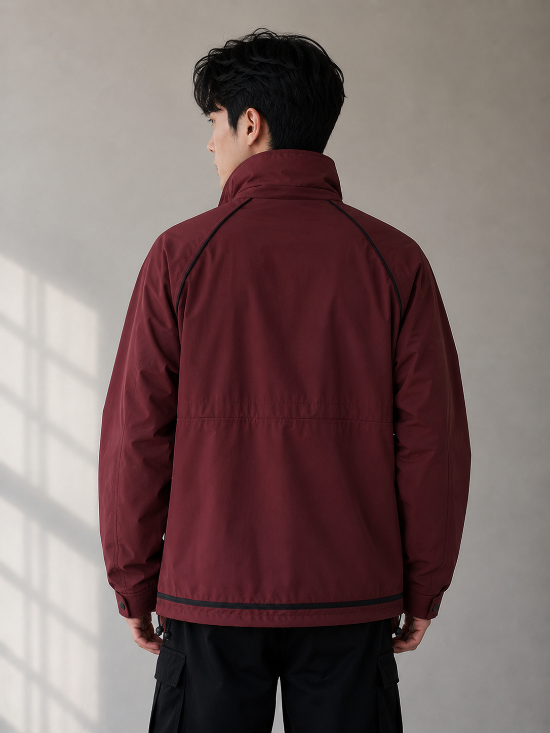 a men's maroon utility jacket featuring a stand collar, structured silhouette, full sleeves, and functional pocket detailing