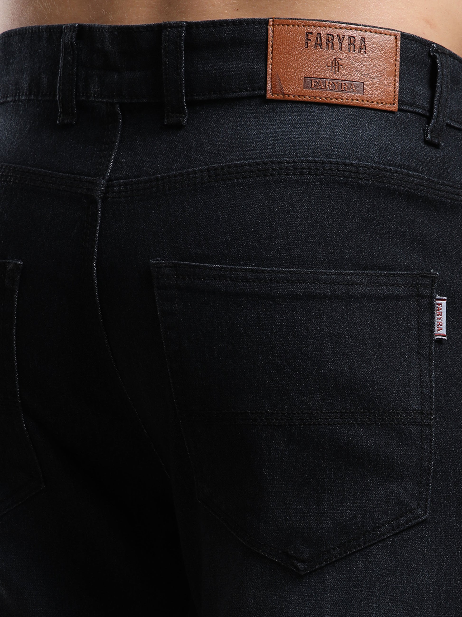 Black jeans with a visible brand label on the back pocket.