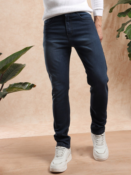 Men slim fit dark wash denim jeans paired with white sneakers, front view.