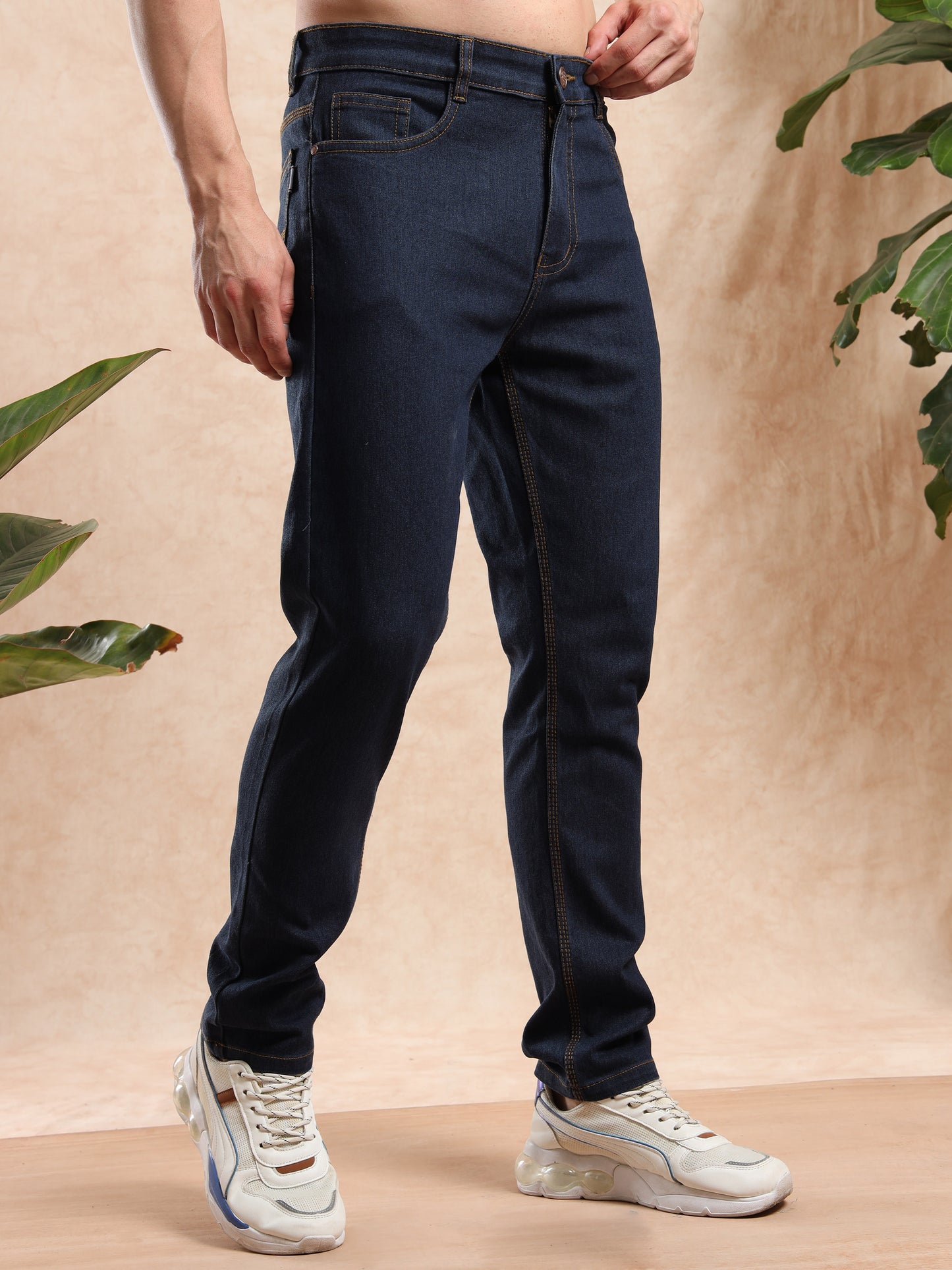 men, dark blue slim fit jeans styled with sneakers
