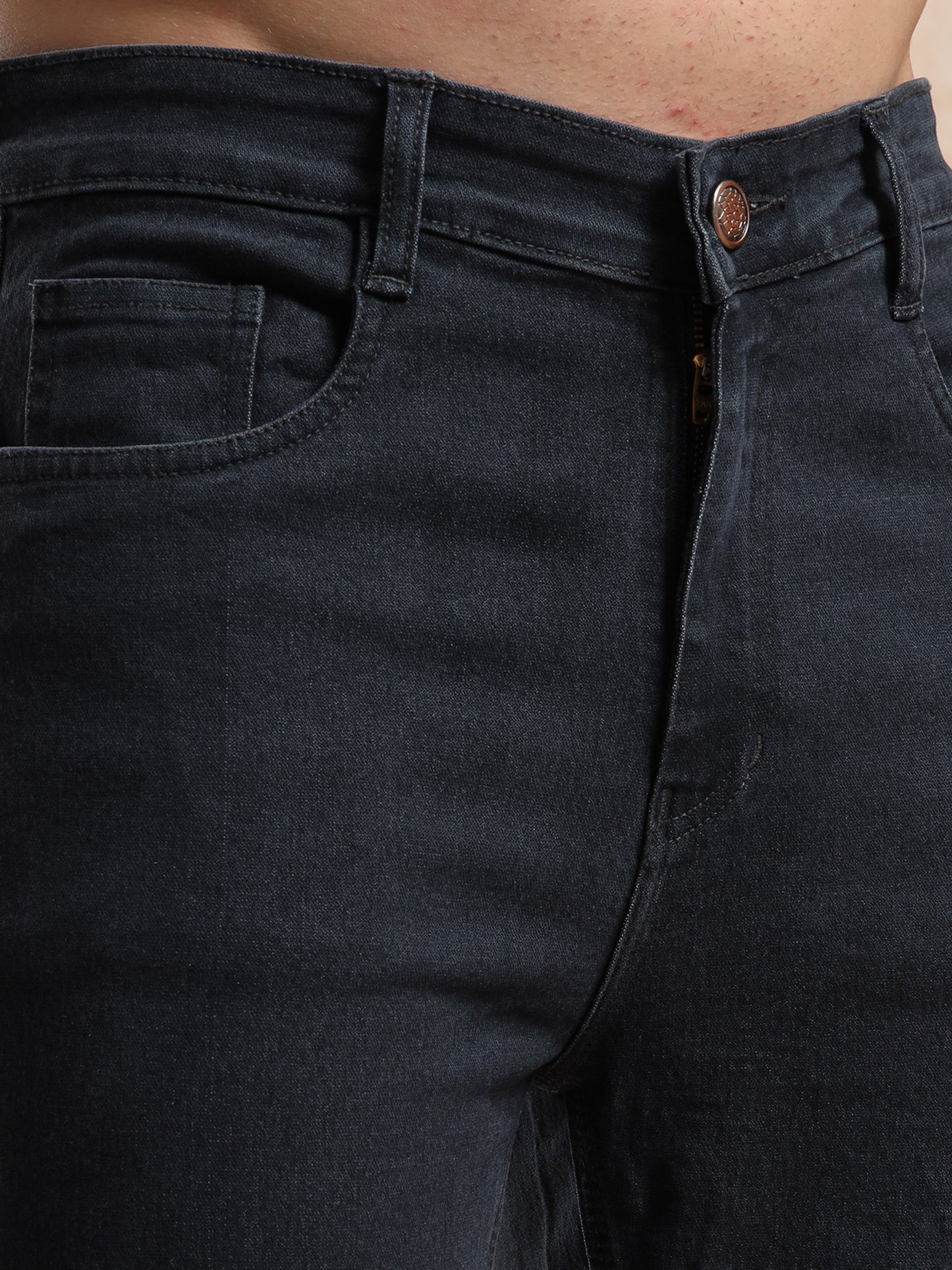 Detailed view of coin pocket and button closure on men, slim fit grey denim