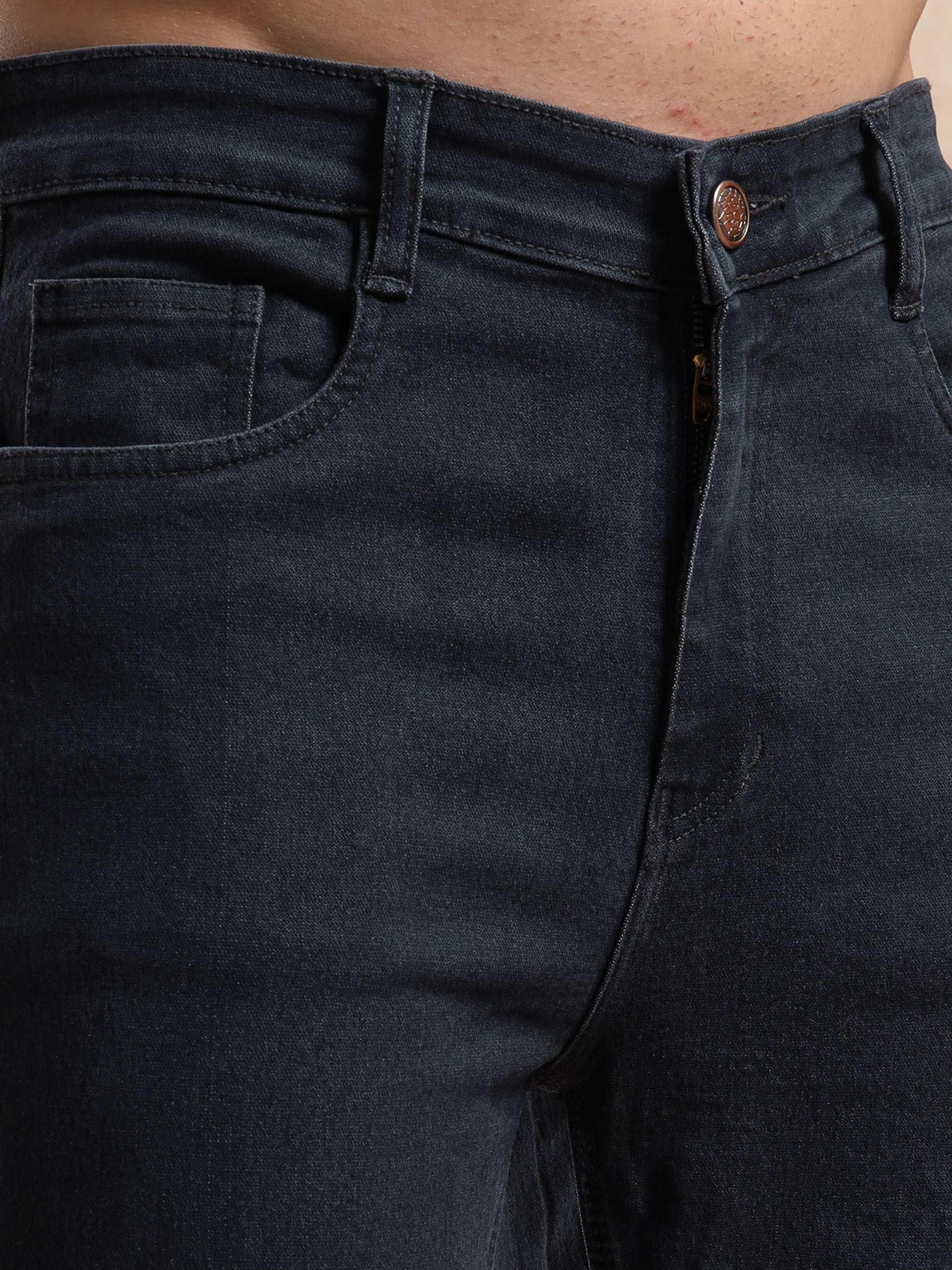 Detailed view of coin pocket and button closure on men, slim fit grey denim