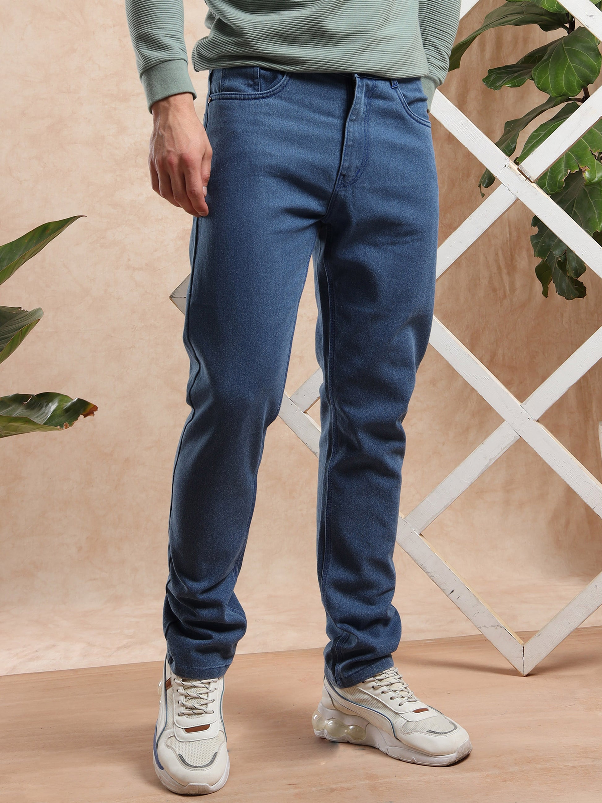 men slim fit blue denim jeans styled with white sneakers