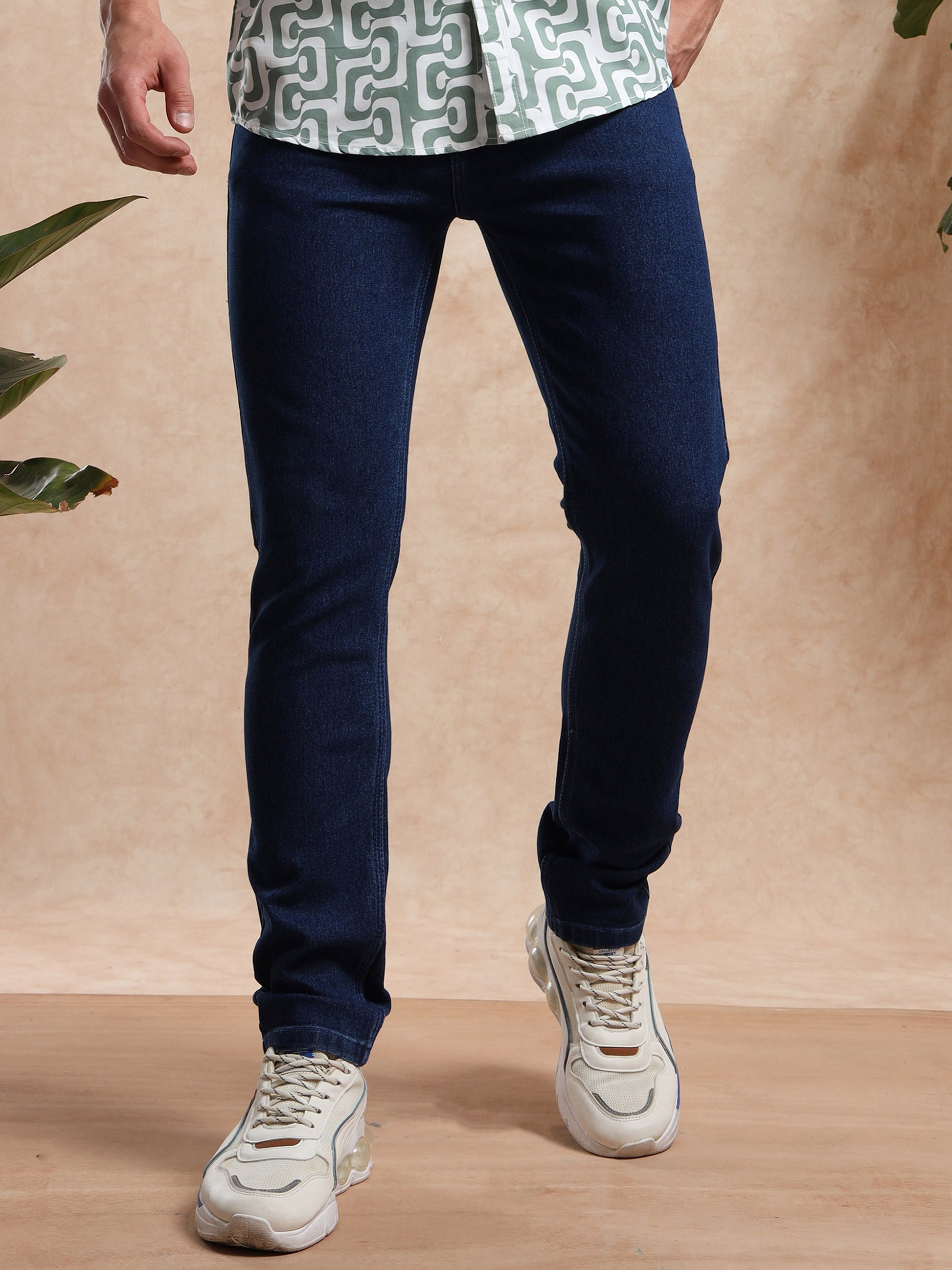 Mens slim fit dark blue denim jeans styled with printed shirt and sneakers  casual wear
